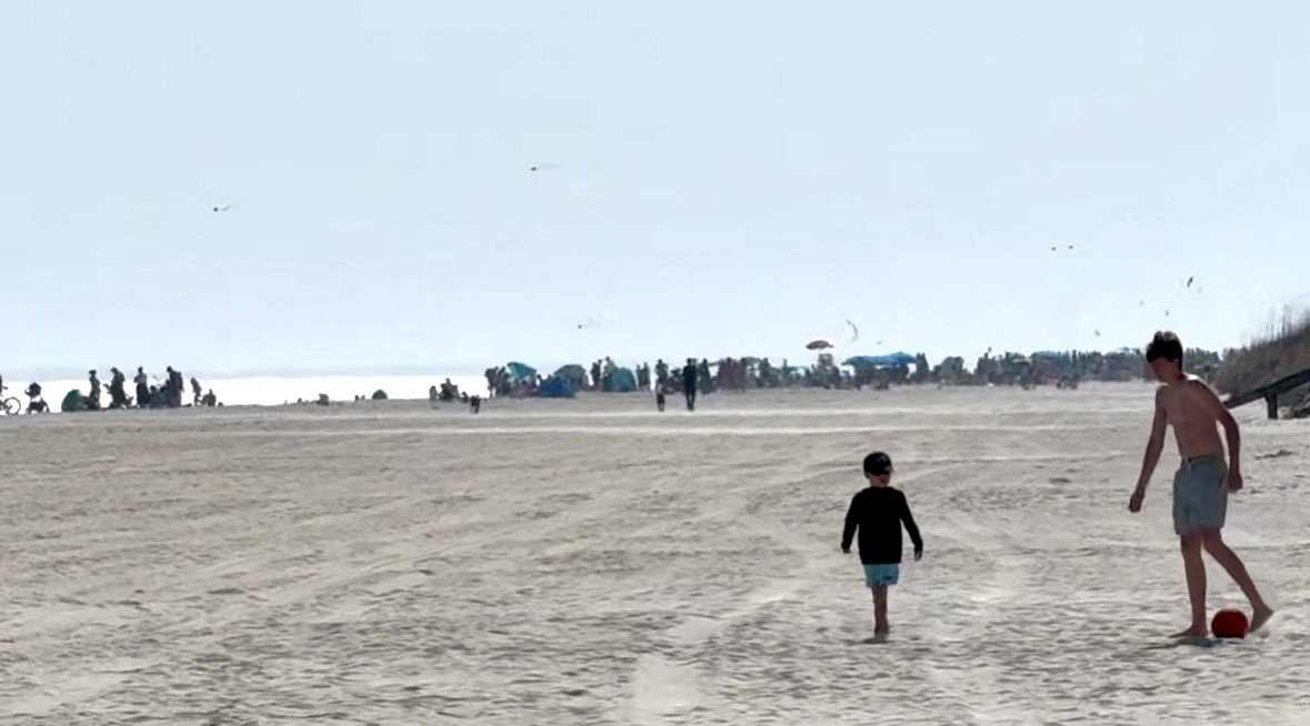 View of crowded Coligny Beach in peak summer from our beach access