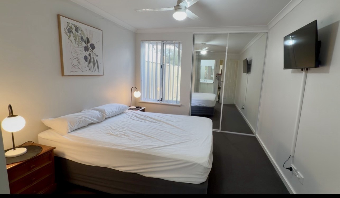 Main Bedroom with queen bed,  tv on the wall & built-in robes