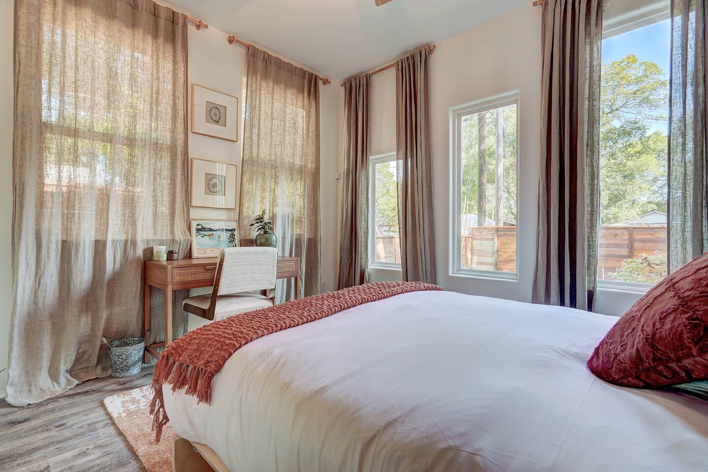 Spacious room with a murphy style queen bed as well as work space and a desk.