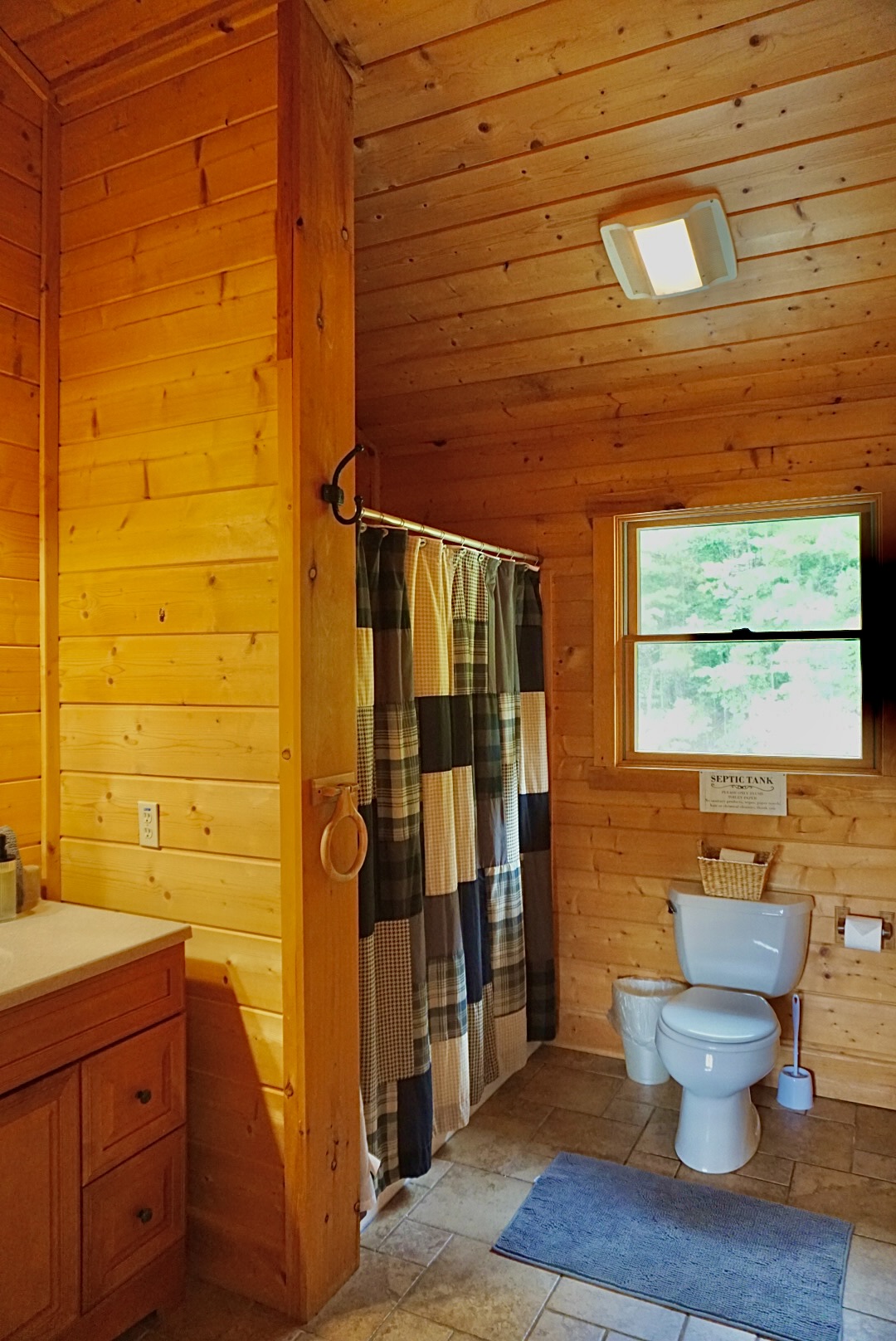 Bright wood accents and a charming shower create a refreshing, rustic vibe!
