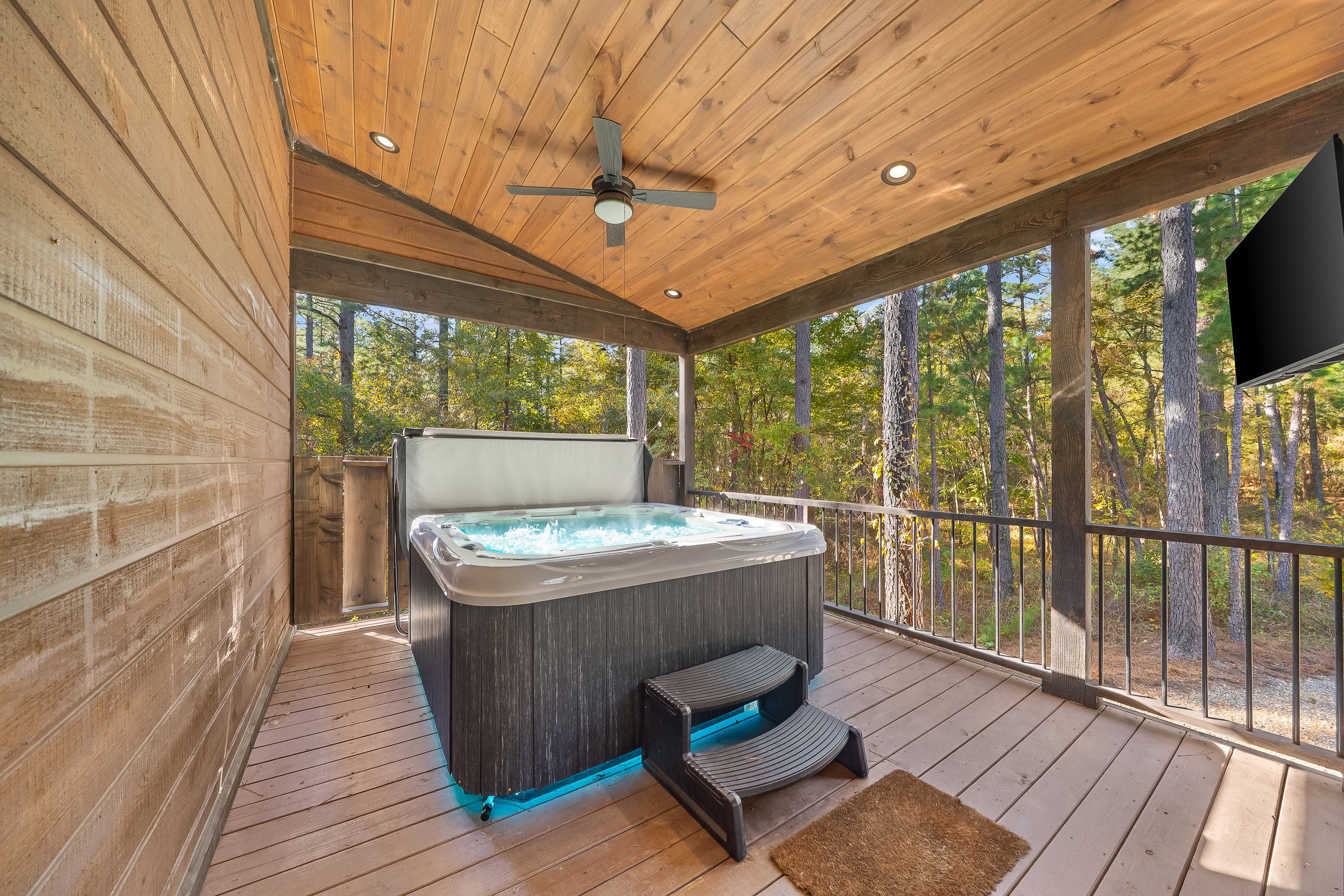Daytime soaks in the hot tub feel refreshing and calm, with bubbling jets, natural light, and peaceful views of the trees all around.