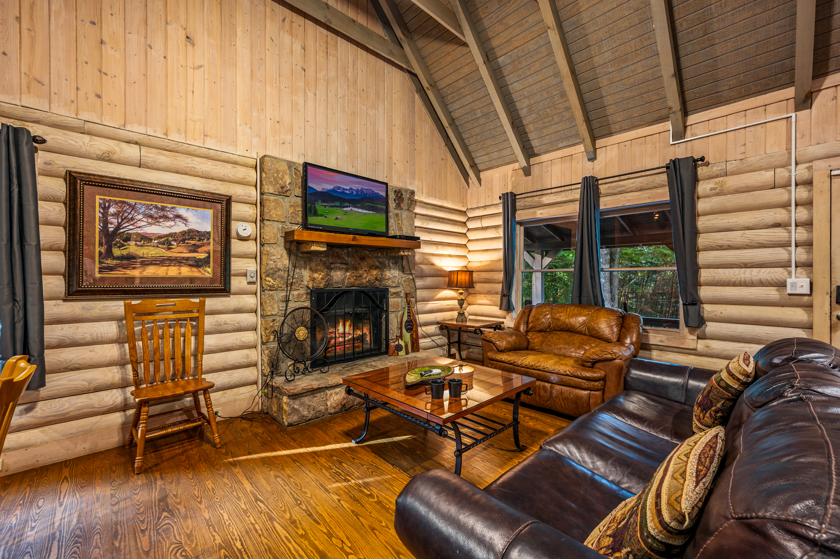 Relax by the stone fireplace in your plush mountain cabin living room.