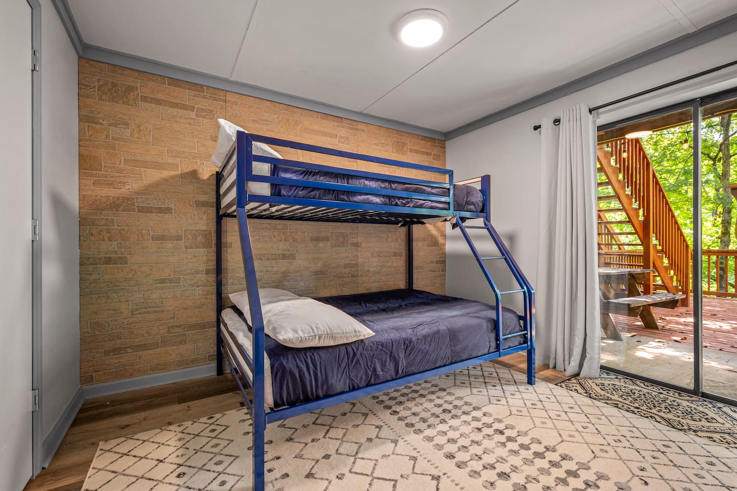 Bunk bed with a full on the bottom bunk and twin on top. Has sliding door to large deck. This room is downstairs, where the game area and 2nd living area is located. 