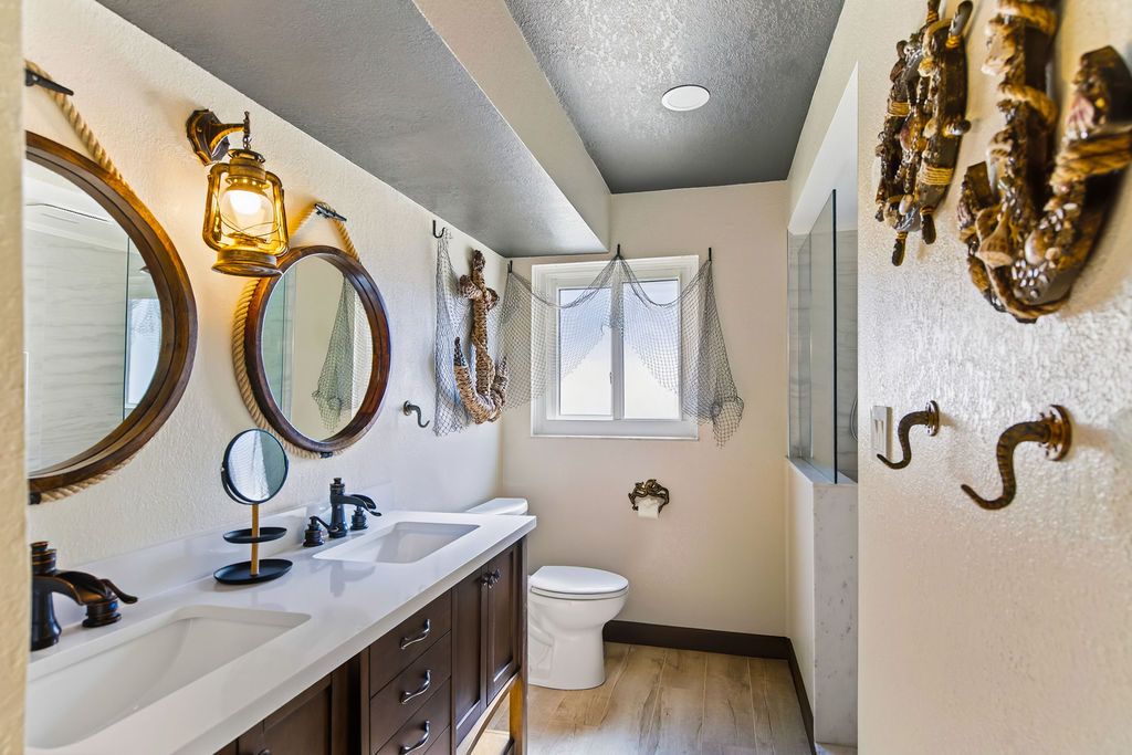 The Salty Shadow – A shared Jack‑and‑Jill bath with shower and twin vanity. Where mermaids and sea monsters cross paths, this hideaway keeps the crew fresh, polished, and ready for the next adventure.