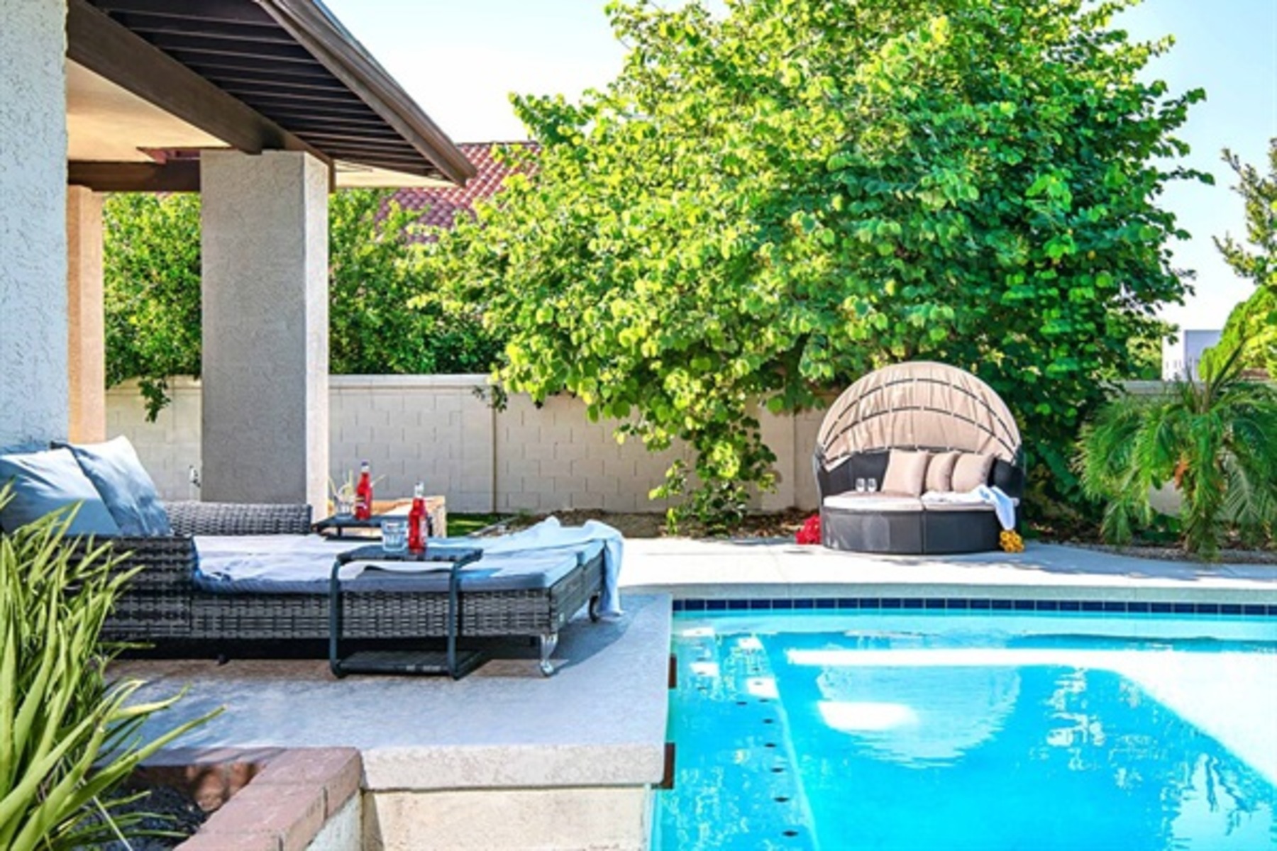 Lounge in style beside the heated pool surrounded by greenery, luxury seating, and total backyard bliss.