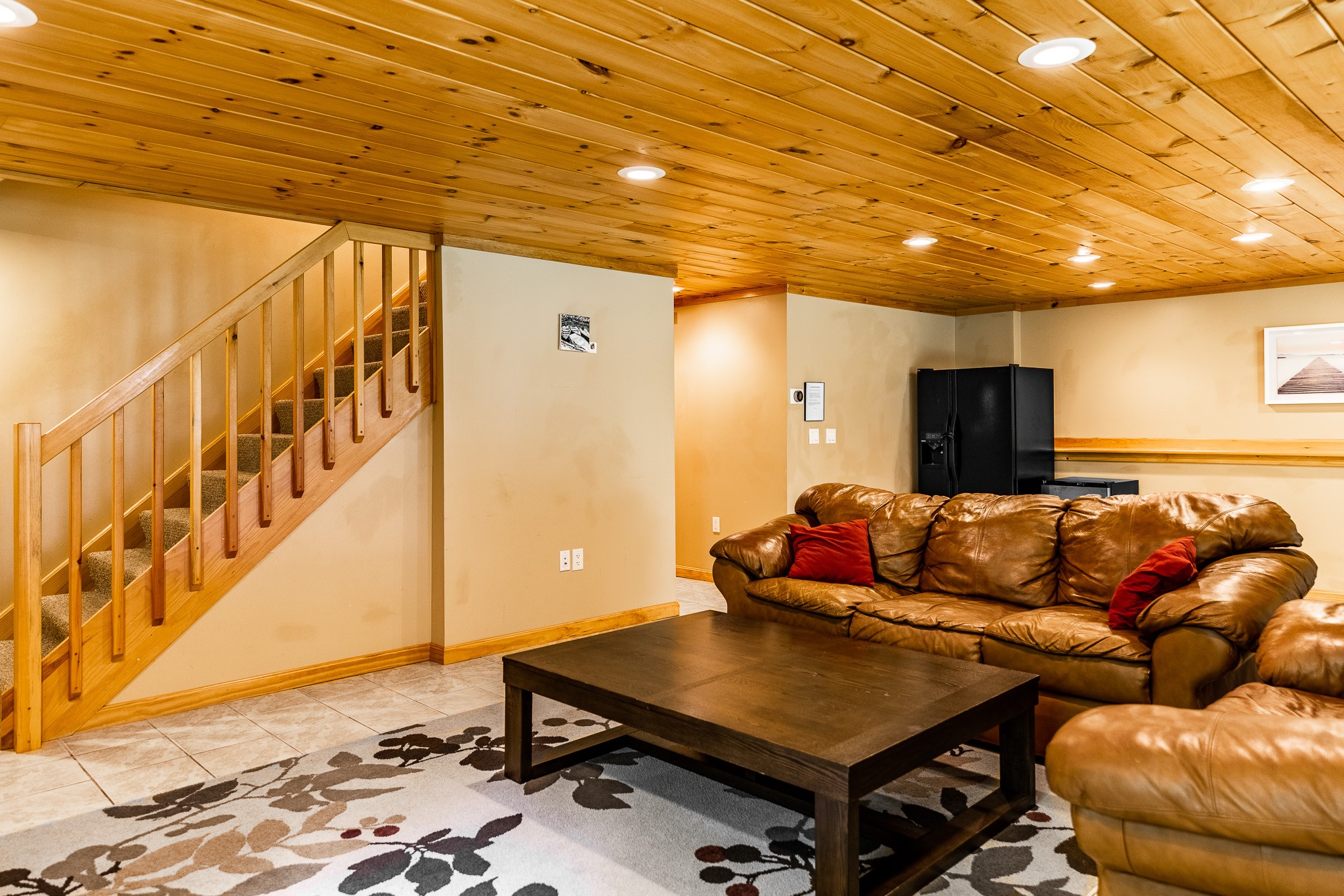 Downstairs entertainment area with comfortable leather couches, Roku TV, DVD player with some movies, drink refrigerator, access to covered and screened outdoor kitchen area.