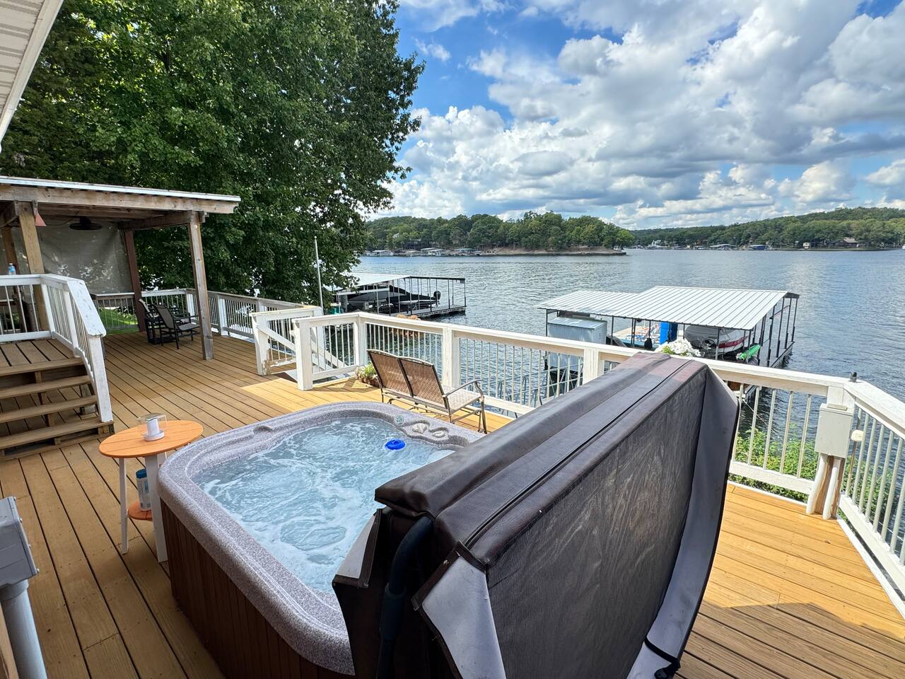 Easy lift hot tub cover and spacious deck with great Lake views.