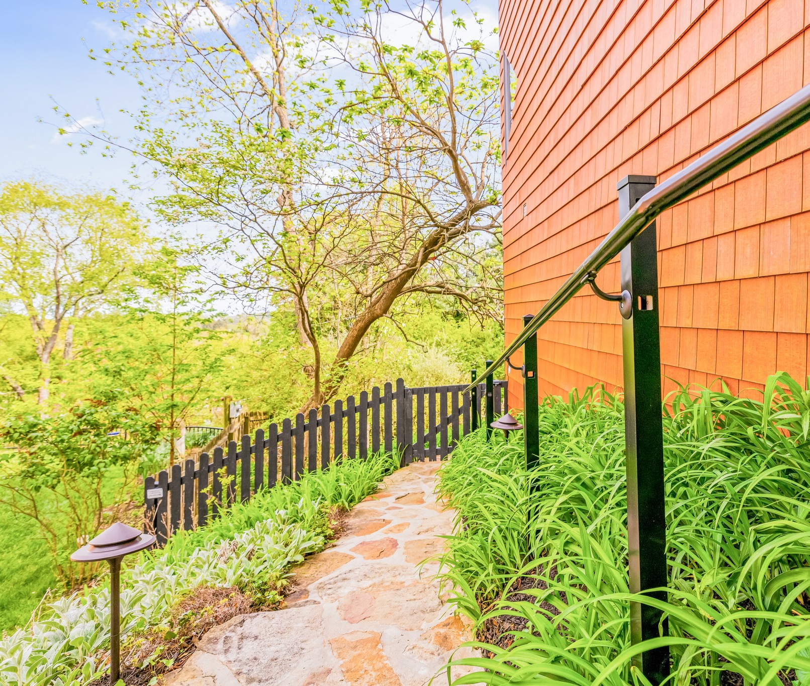 Stone stairs down around the house create another way to move into or out of the lower floor and enjoy gardens too! Take a left off the front porch and use the large, long stone stairs to the Koi Pond deck. Easy peasy!
