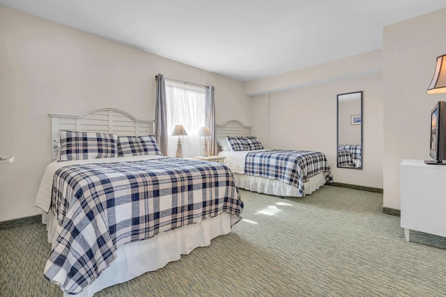 Cozy second bedroom featuring two double beds