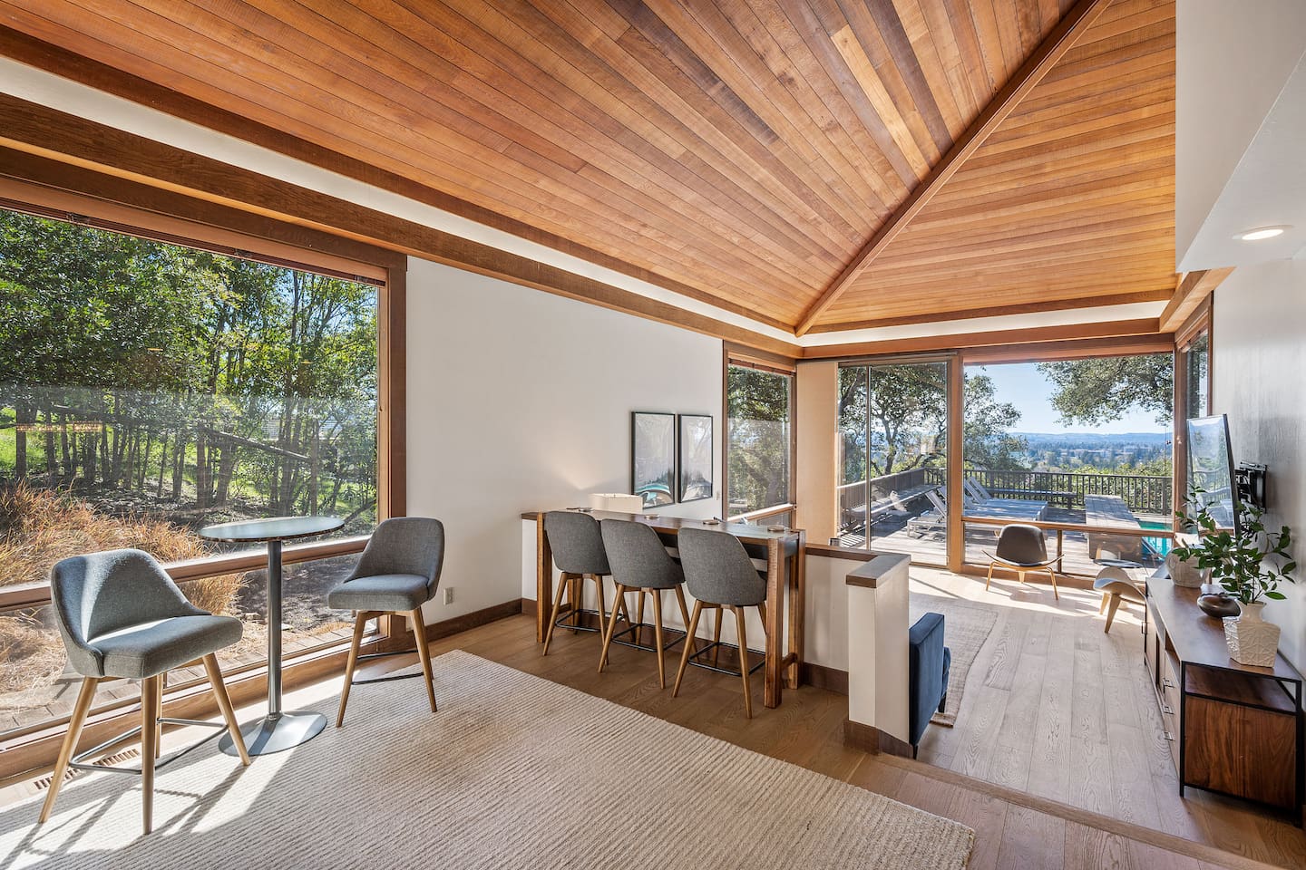 Haven is special for its large indoor and outdoor communal spaces. Two-level living room with a 80" 4k TV sits next to the kitchen and dining room. Both rooms open to the back deck with the pool, hot tub, and outdoor dining.
