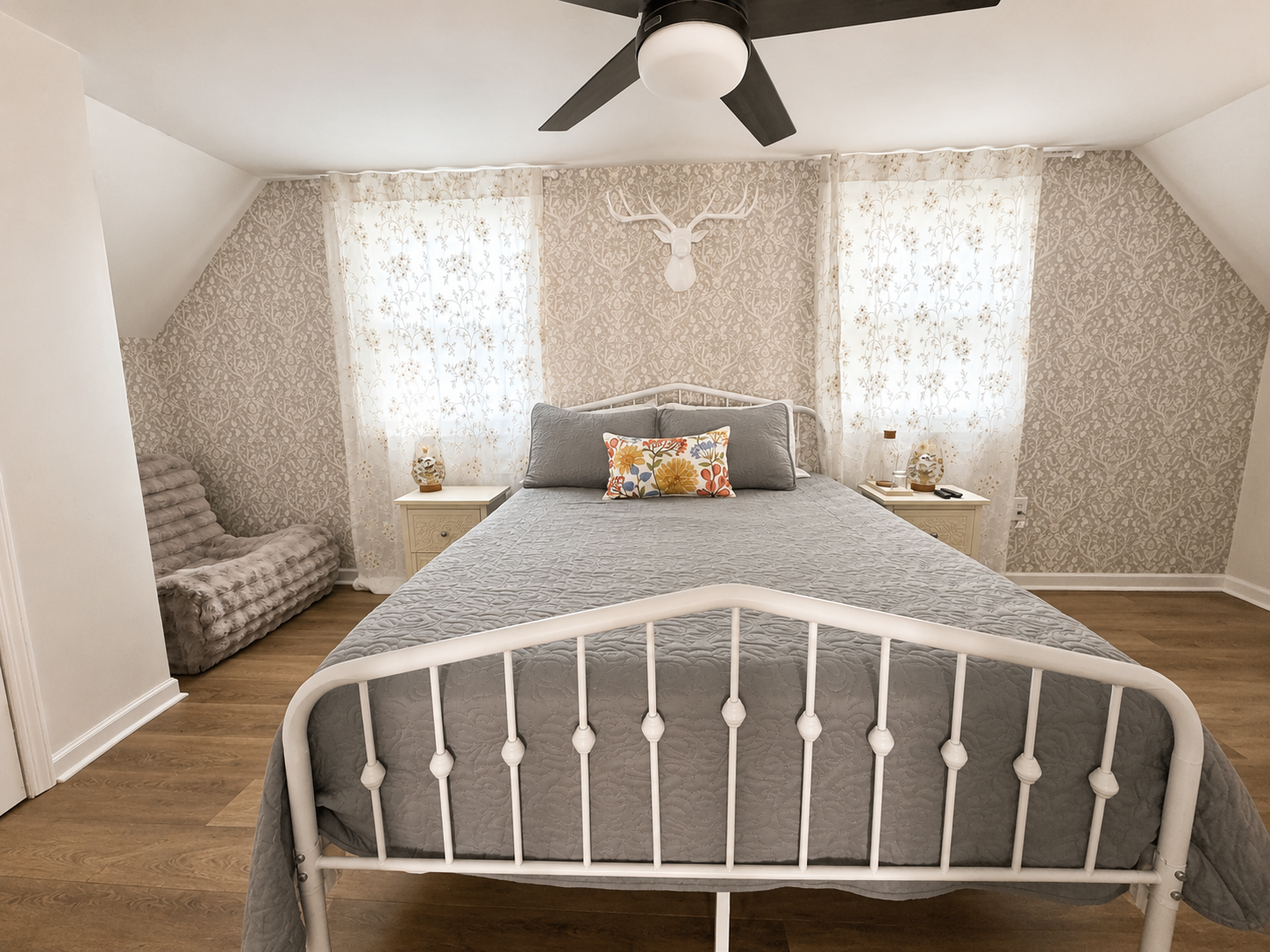 Charming second-floor primary bedroom with a queen bed, natural light and a cozy retreat feel near the upstairs loft and deck.