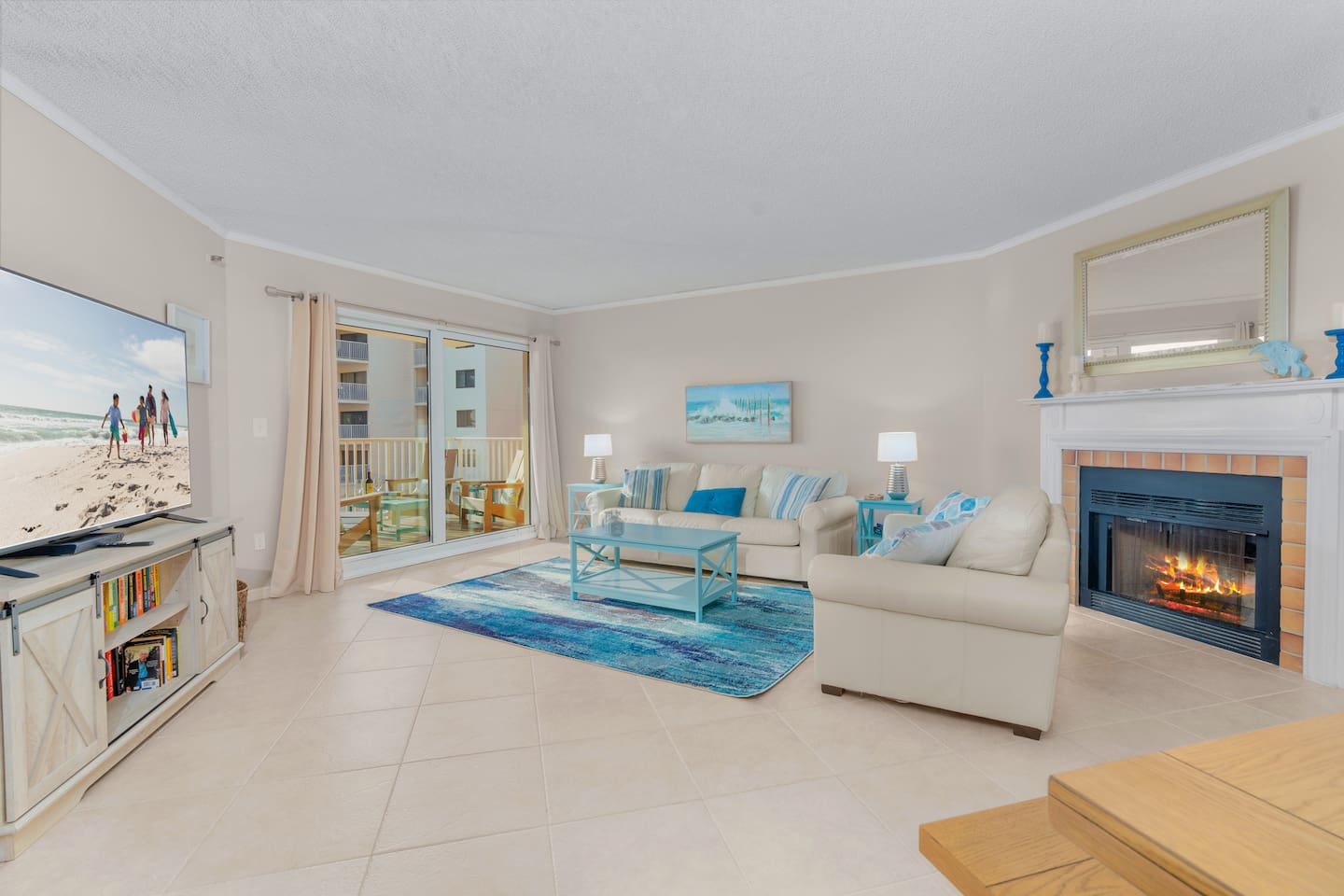 Huge open cozy living room with 70-inch LED Smart TV, Fireplace and Gulf Views