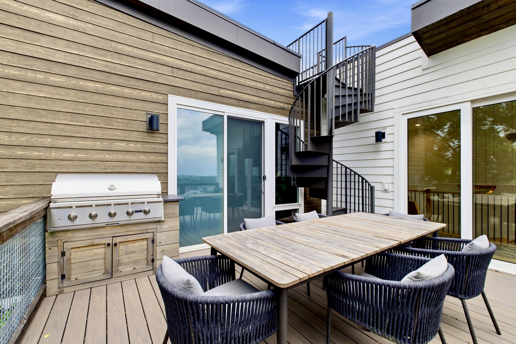 Private deck w/ a gas grill, dining table & outdoor seating — ideal for an al fresco cookout.
