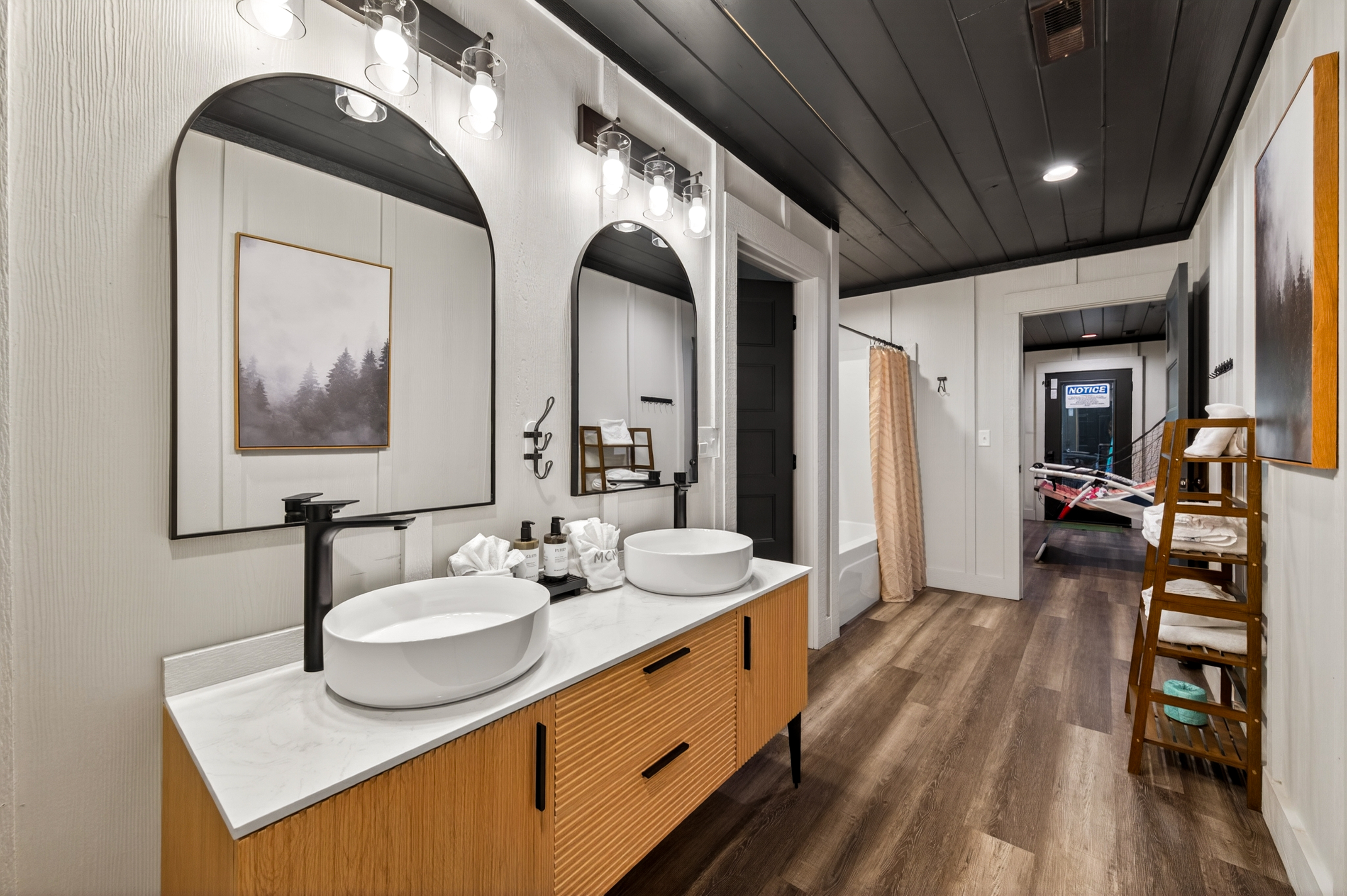 Bunk room bathroom. Double sink vanity, bathtub and shower.