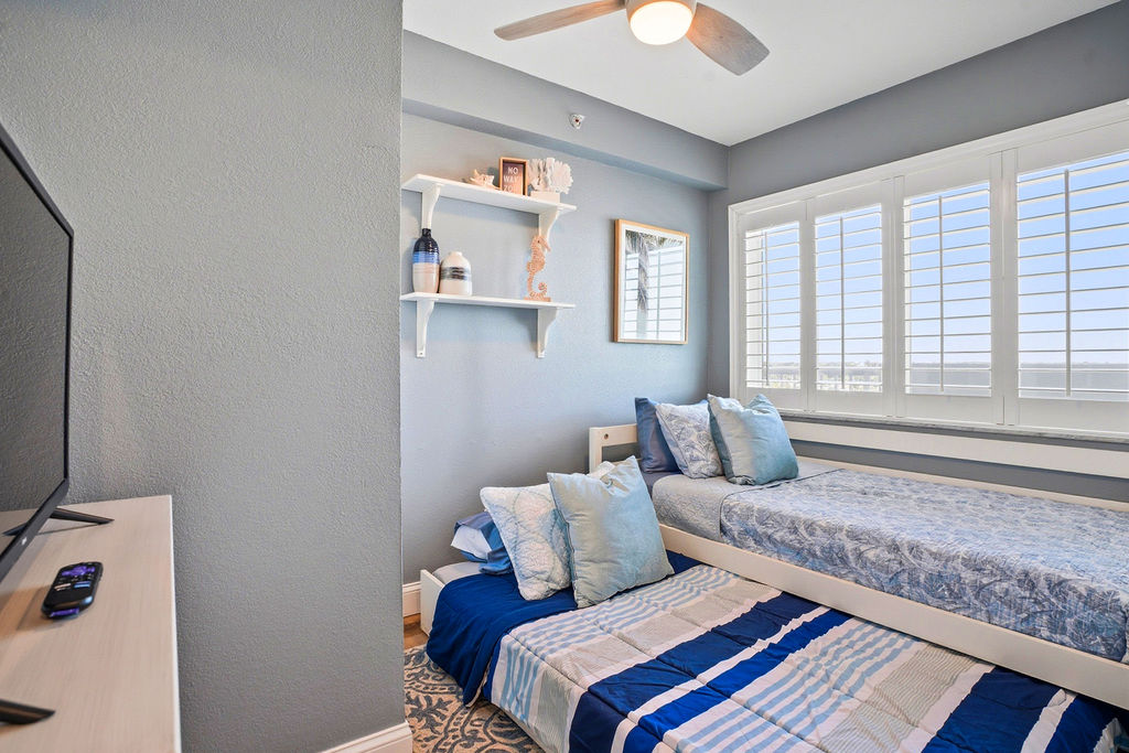 Family-friendly bedroom in this beachfront vacation rental featuring trundle twin beds perfect for kids.