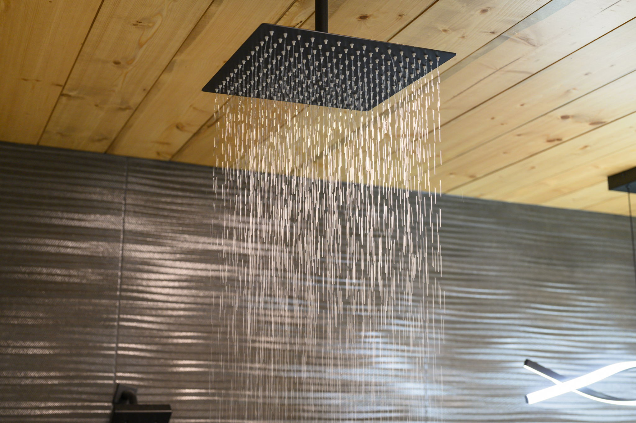  Private en-suite bathroom with a rain shower and serene, luxury-cabin feel.