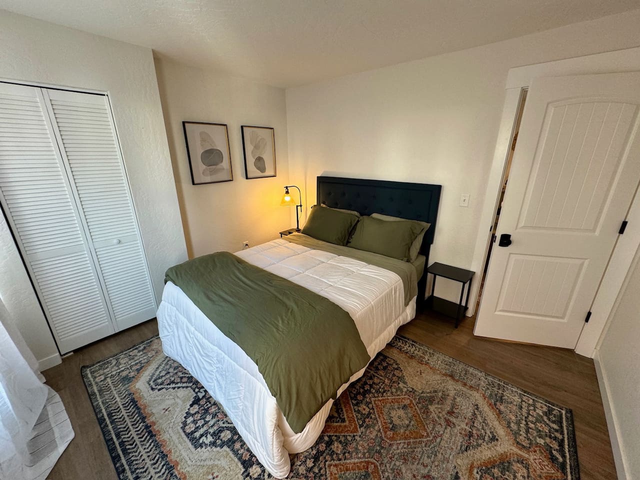 This bedroom features a queen bed, black out curtains, and generous closet space. 