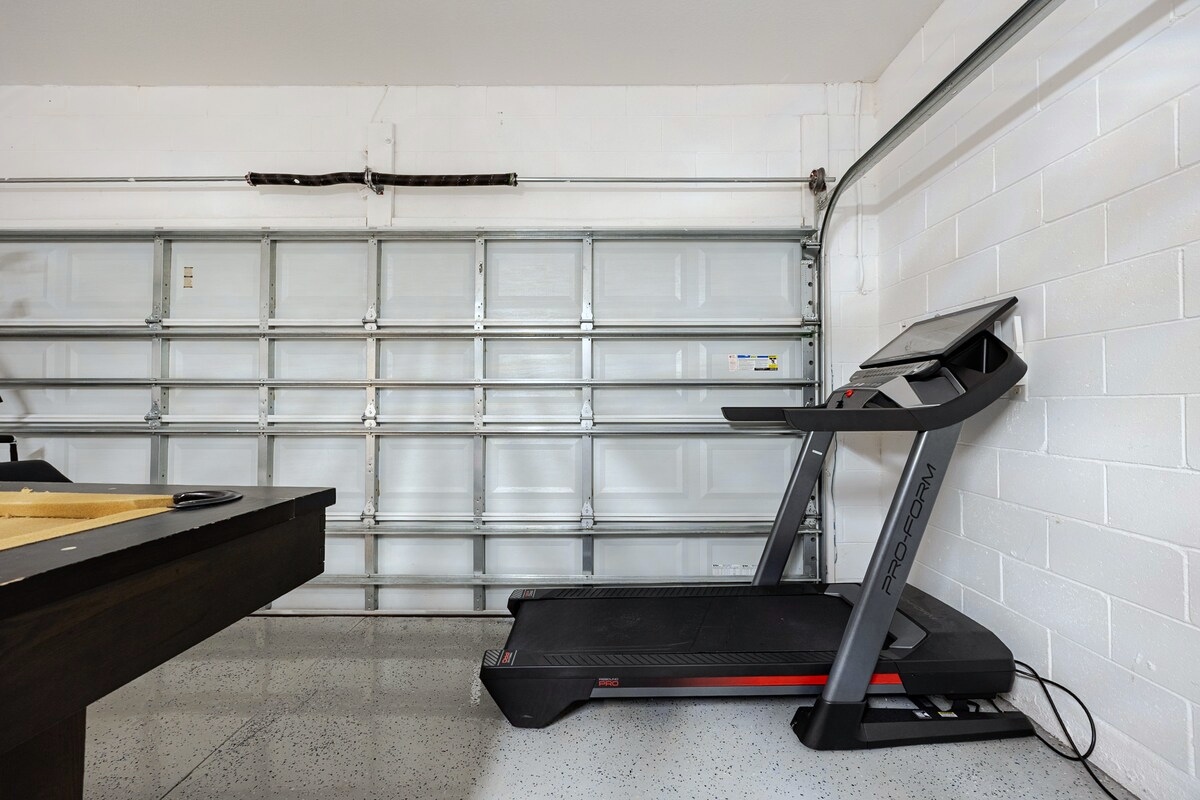 Treadmill in the home’s private garage exercise area.