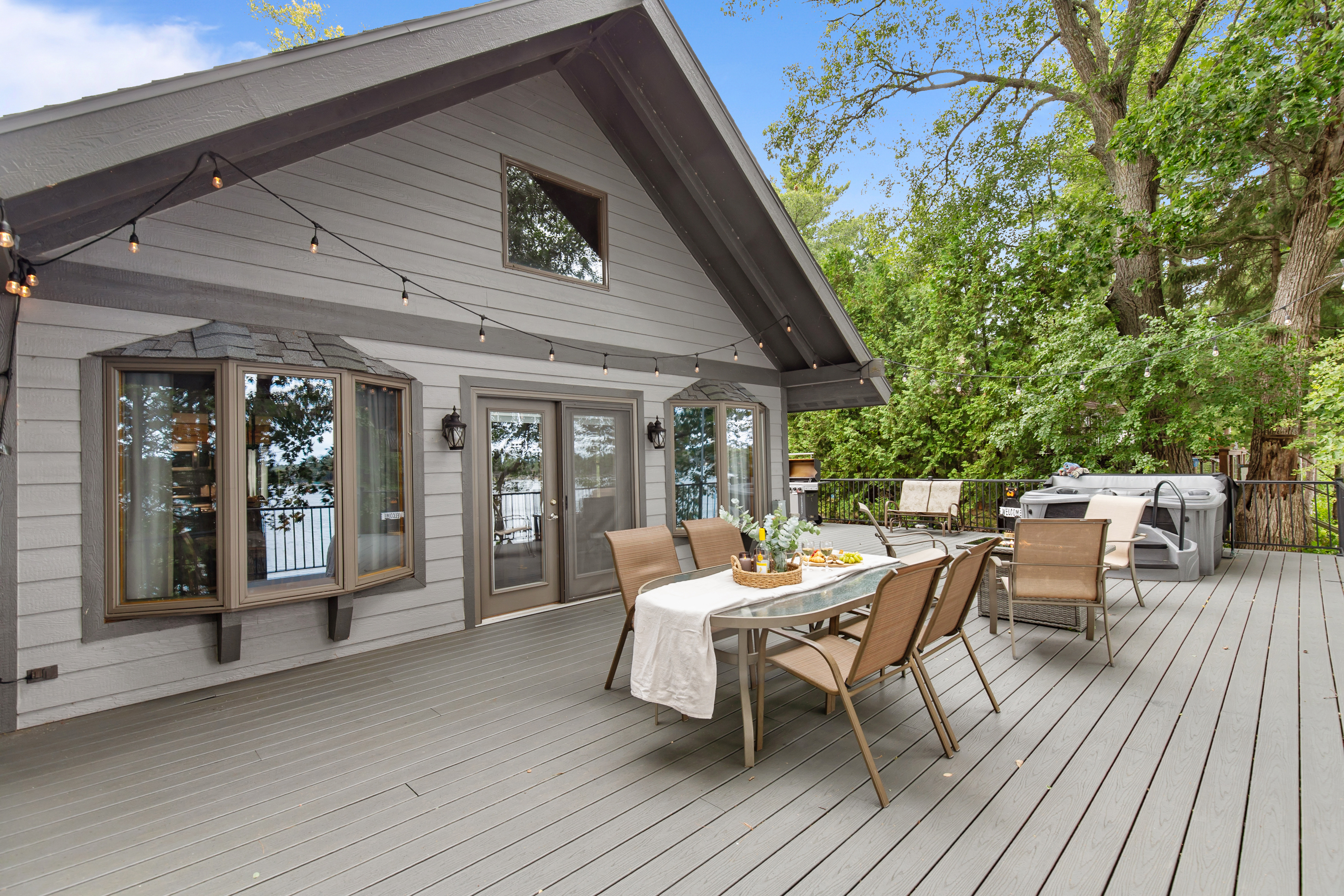 The spacious deck invites you to soak in the hot tub, gather by the fire, or enjoy outdoor dining—all while taking in the peaceful lake views.”