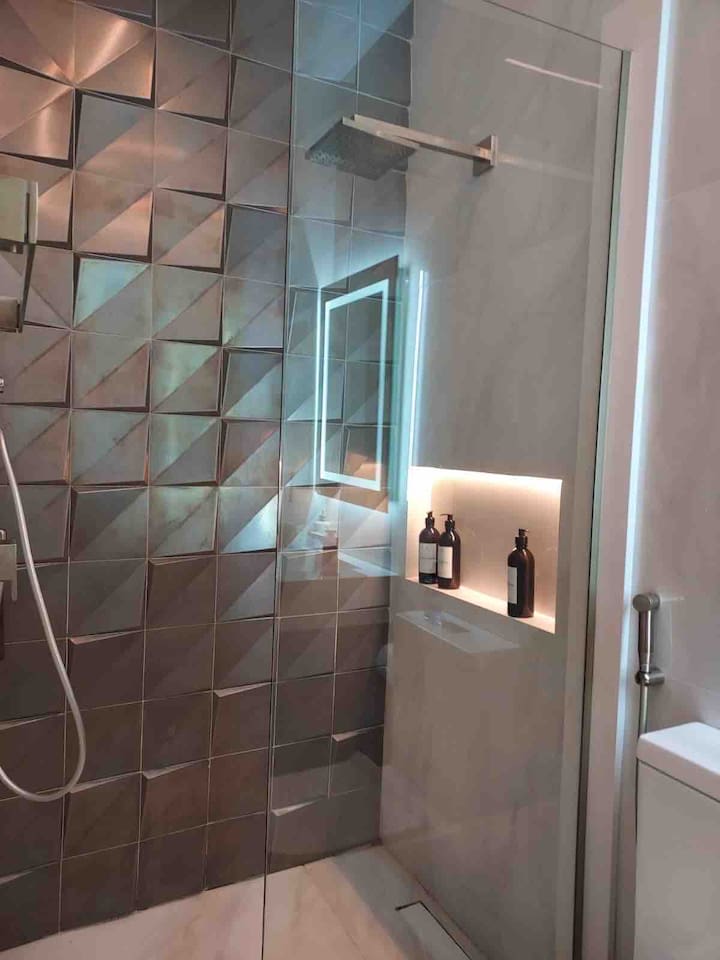 Full bathroom near sauna and BBQ.