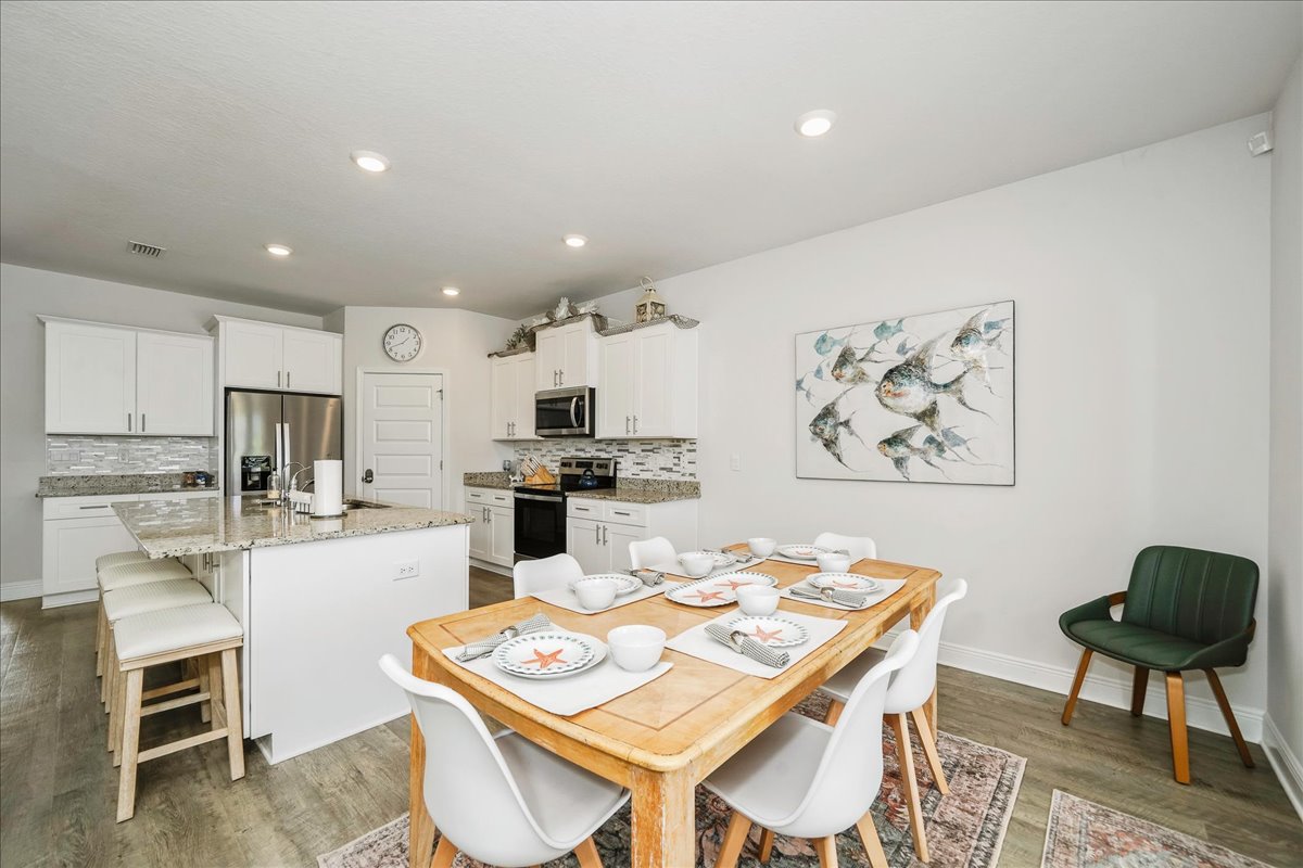 bright dining area designed for gathering, featuring seating for six and plenty of natural light.