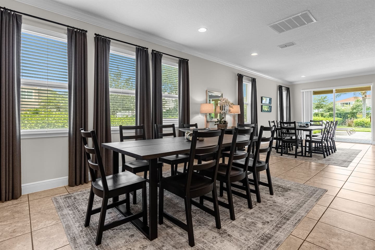 Dining area with two elegant eight-seater dining tables, perfect for accommodating large groups and shared meals.