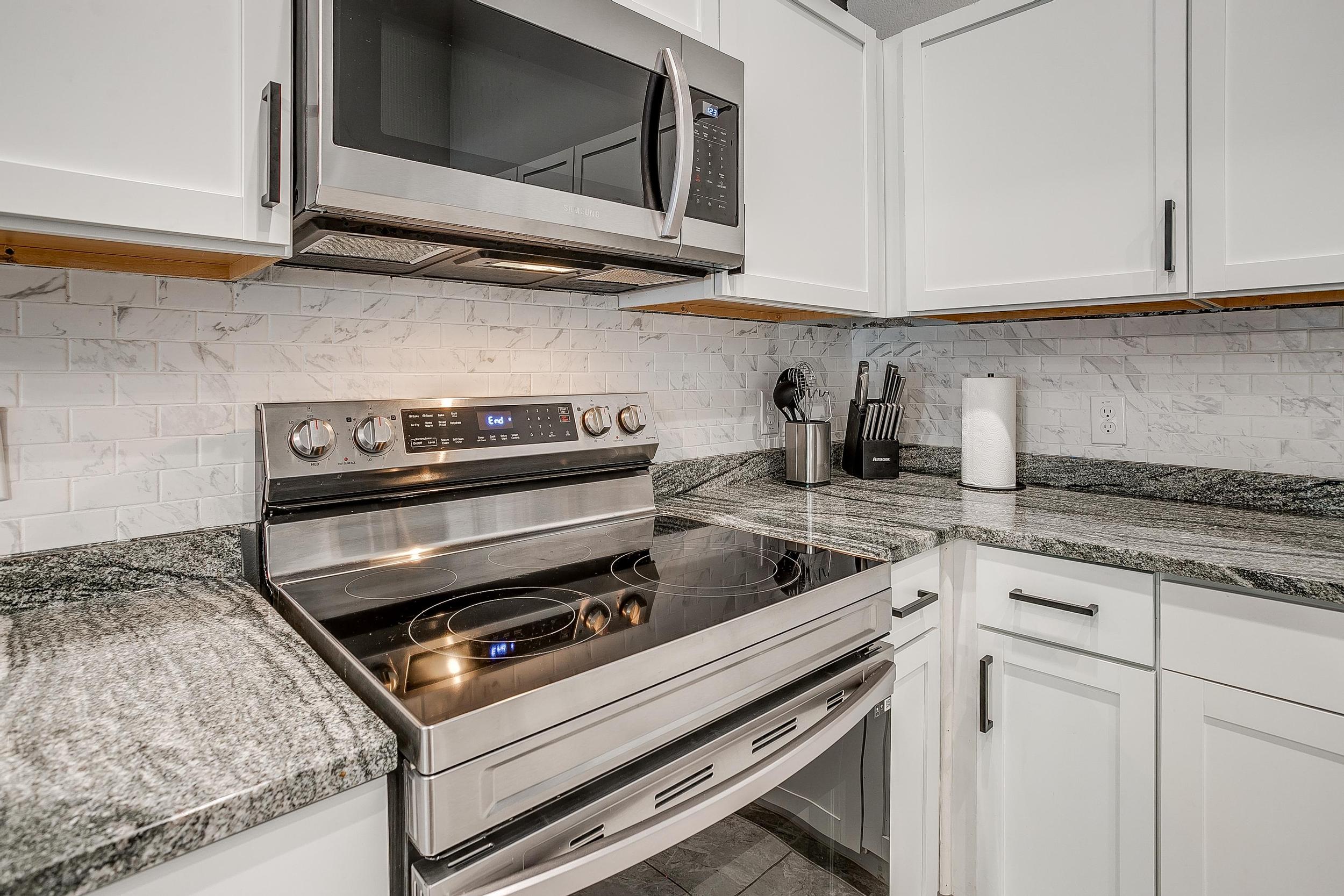 Modern oven + smooth countertops ready for home-cooked meals.