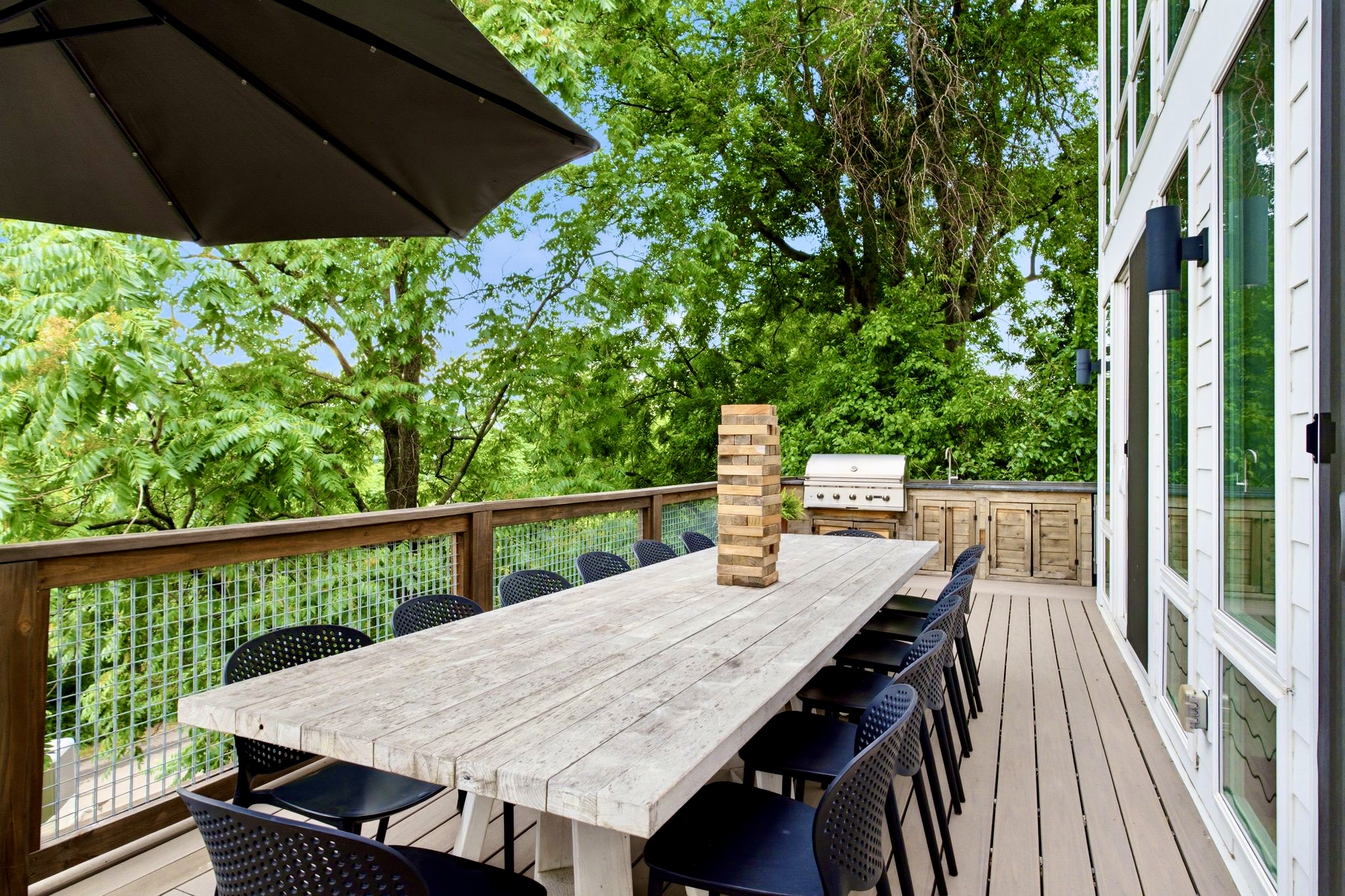 Deck dining table perched among the treetops — grab a drink & settle in for the evening.
