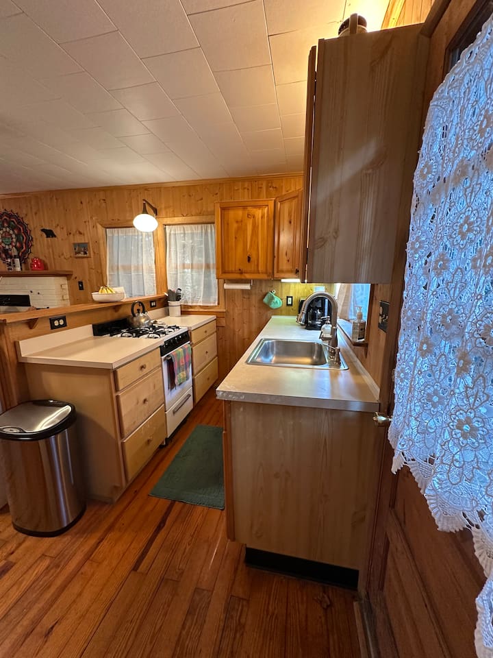 Fully stocked kitchen with everything you need—cookware, utensils, dishware, and coffee maker. Compact yet efficient, ready for cooking meals or enjoying takeout with ease.