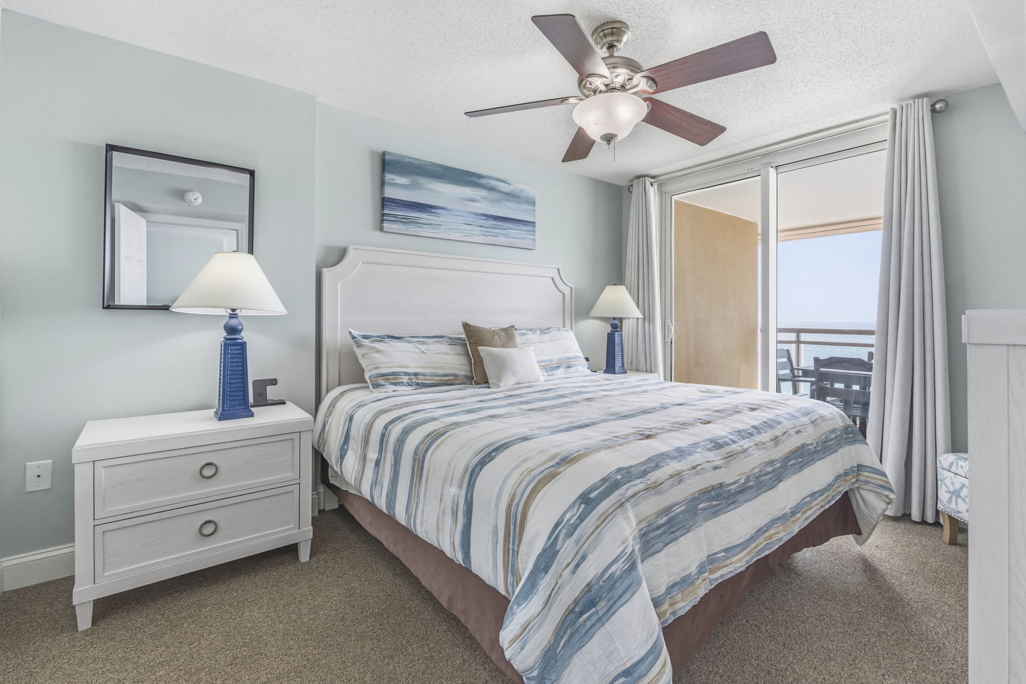 Primary Bedroom with King Bed, ensuite bathroom, and balcony with direct oceanview