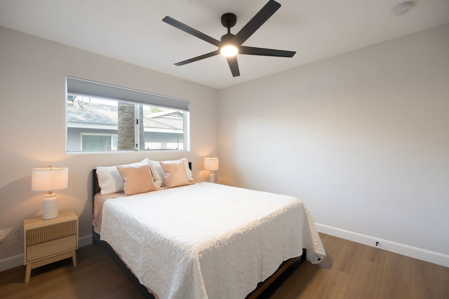 Bright queen bedroom with cozy bedding, soft lighting, and ample closet space.