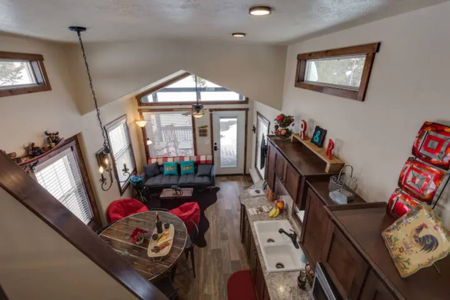 View of living, dining and kitchen area from loft