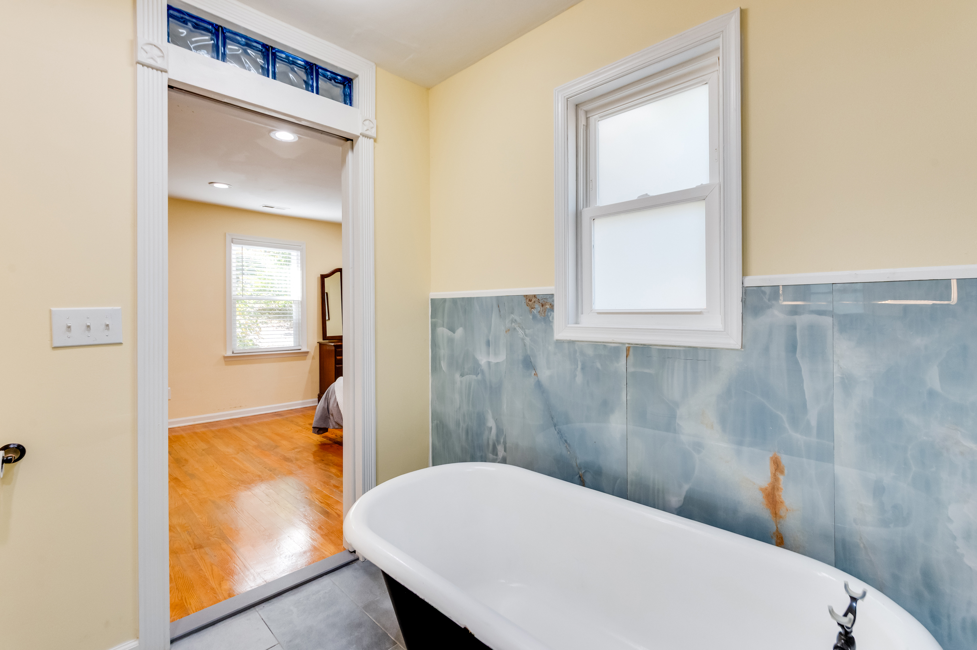 Upstairs Ensuite Full Bathroom 2: Elegant soaking tub awaits! Natural light fills the space for a refreshing escape.