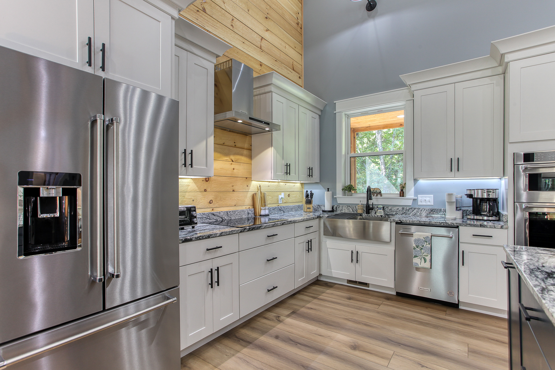 The kitchen at Robbin’s Nest on Snowbird Creek combines warm wood accents with modern conveniences, including a full-size refrigerator and dishwasher.