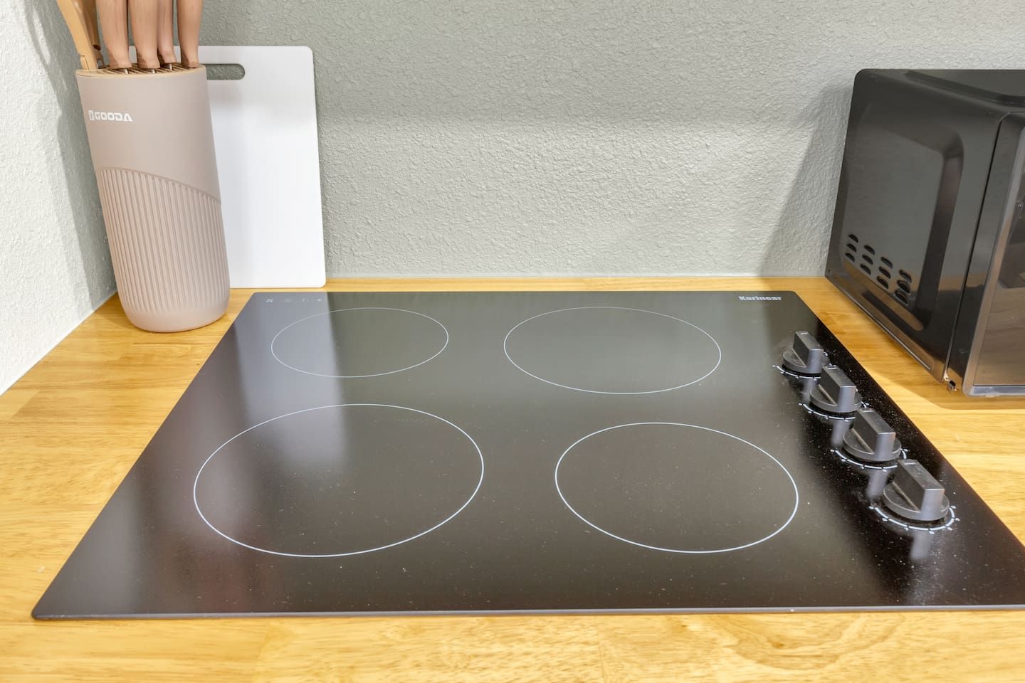 Fully equipped kitchen with a modern electric stove; perfect for cooking homemade meals during your Dallas stay.
