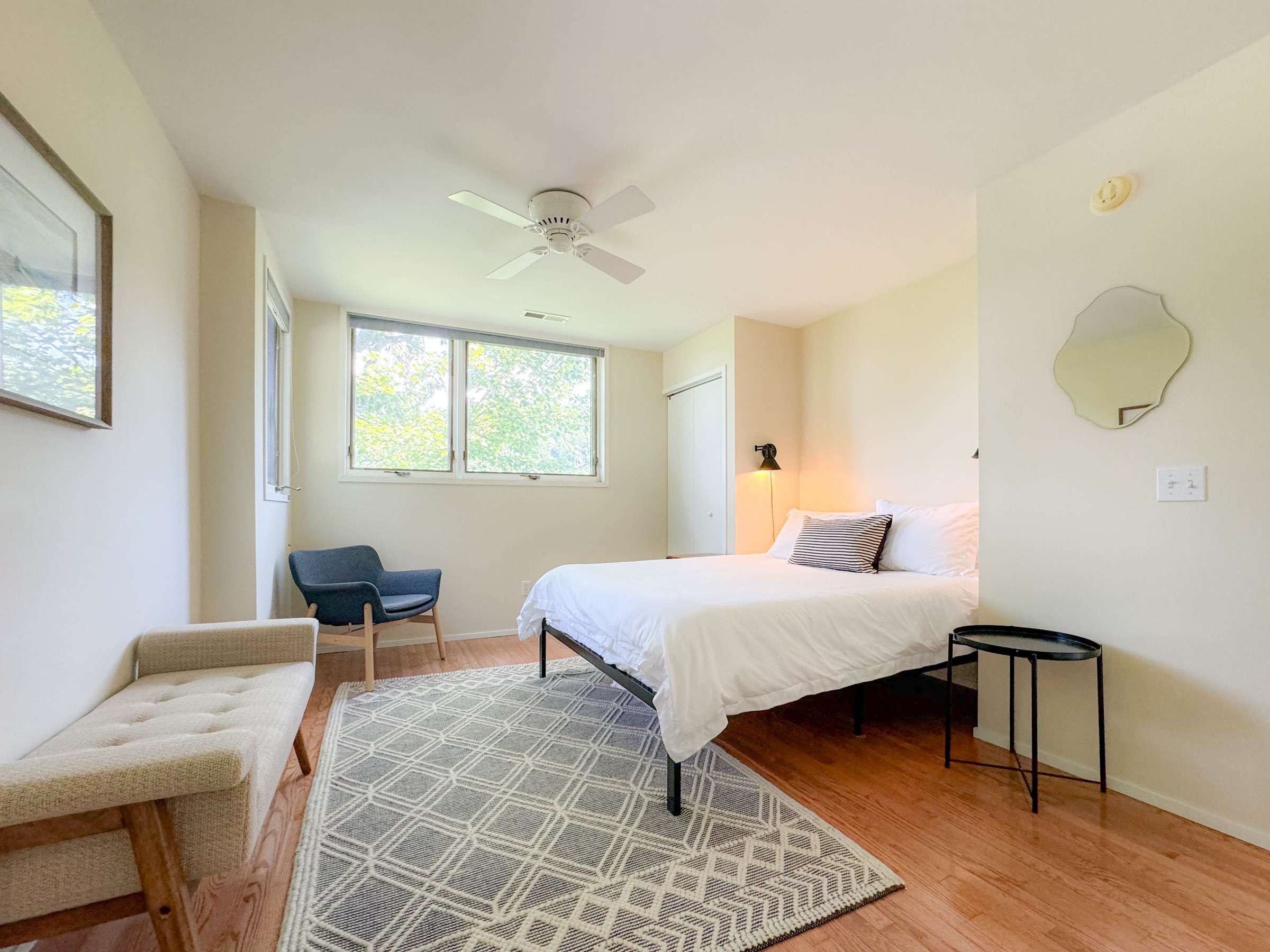 The 2nd bedroom upstairs features a comfy queen size bed and very spacious room. This is the largest bedroom in the house. This bedroom is also complete with plenty of natural light and has a treetop feel.