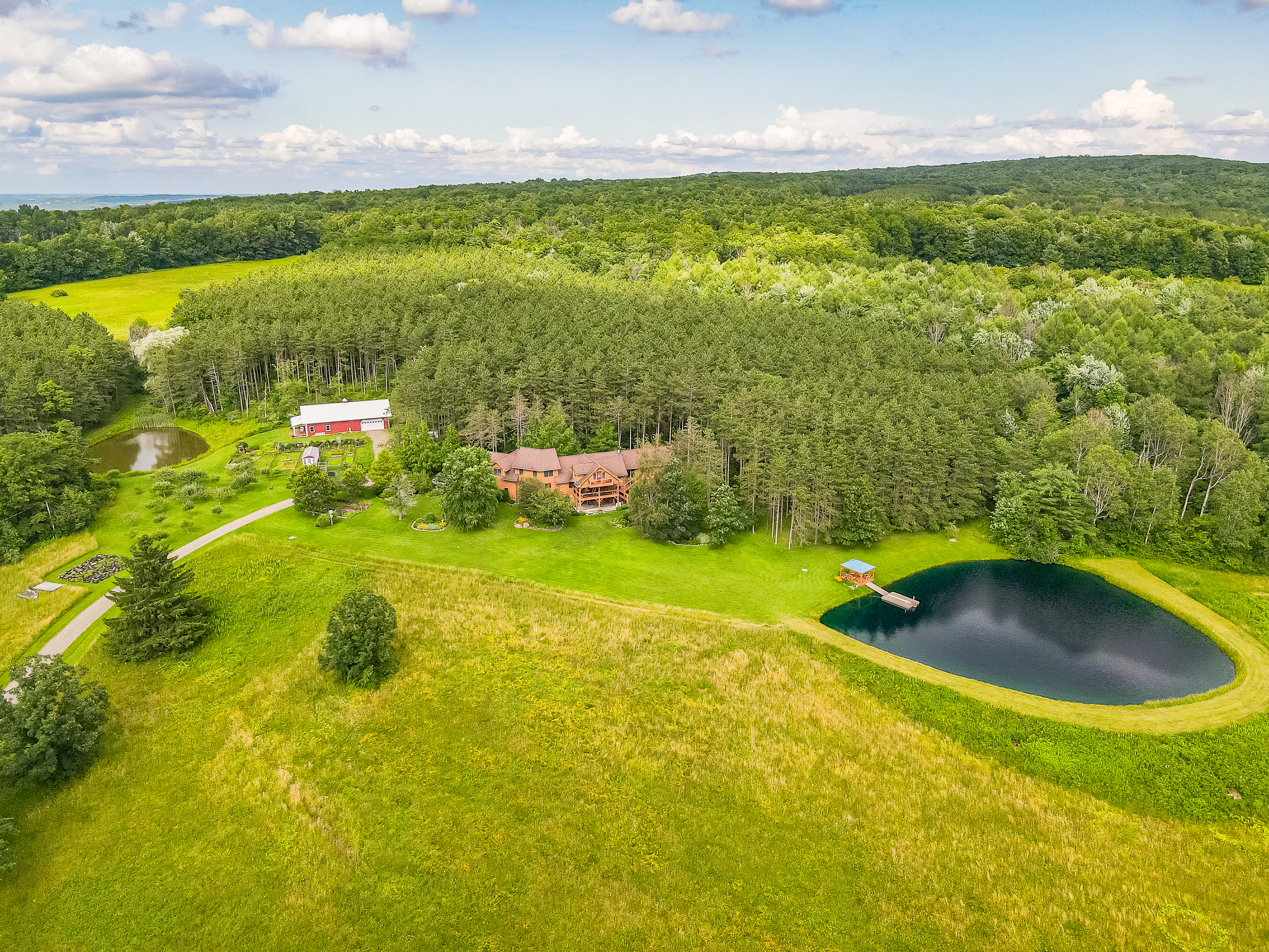 Expansive countryside estate with rolling fields, private pond, barn, and endless space to roam.