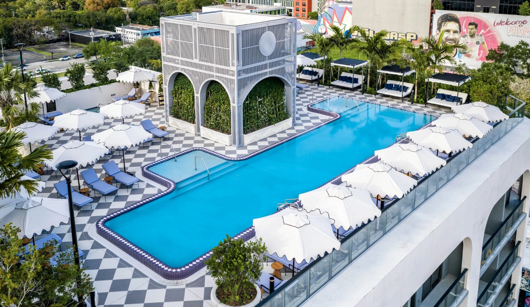 Rooftop saltwater pool — checkered deck, cabanas and Miami skyline backdrop