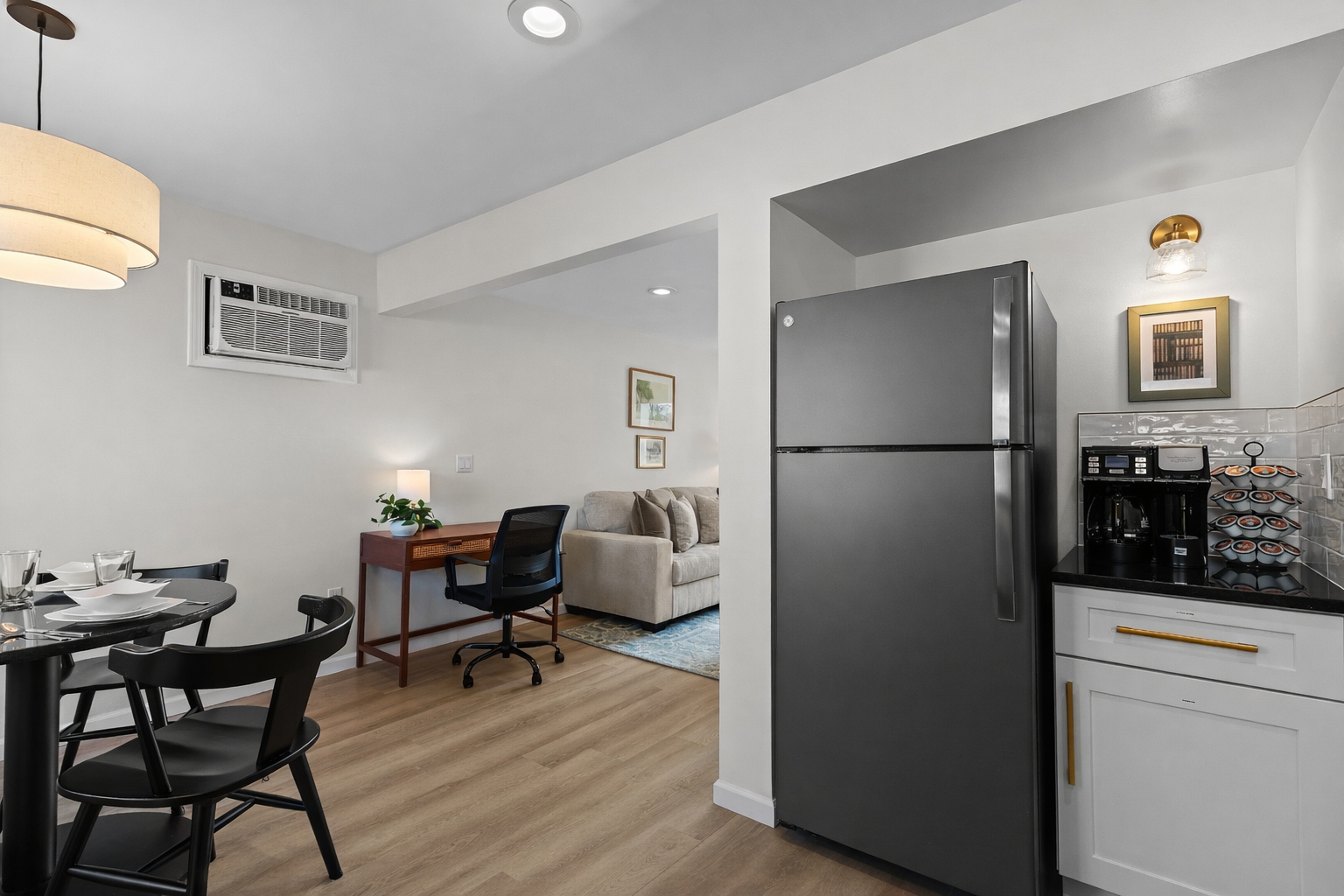 Open kitchen and dining layout with modern appliances, coffee station, and easy flow into the living and workspace areas for everyday comfort.