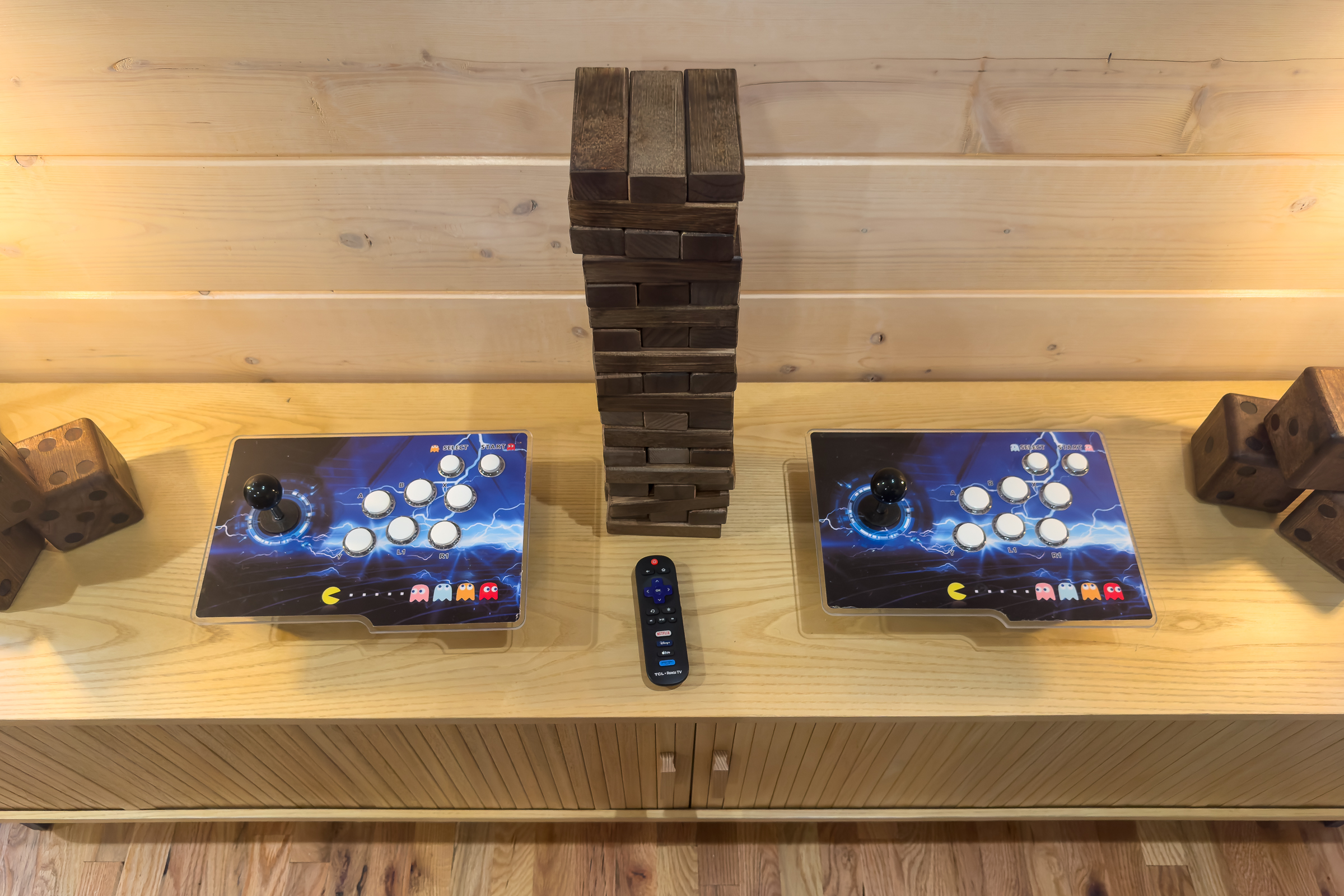 Dual arcade-style controllers and oversized Jenga pieces create the perfect hangout zone for kids and kids at heart.