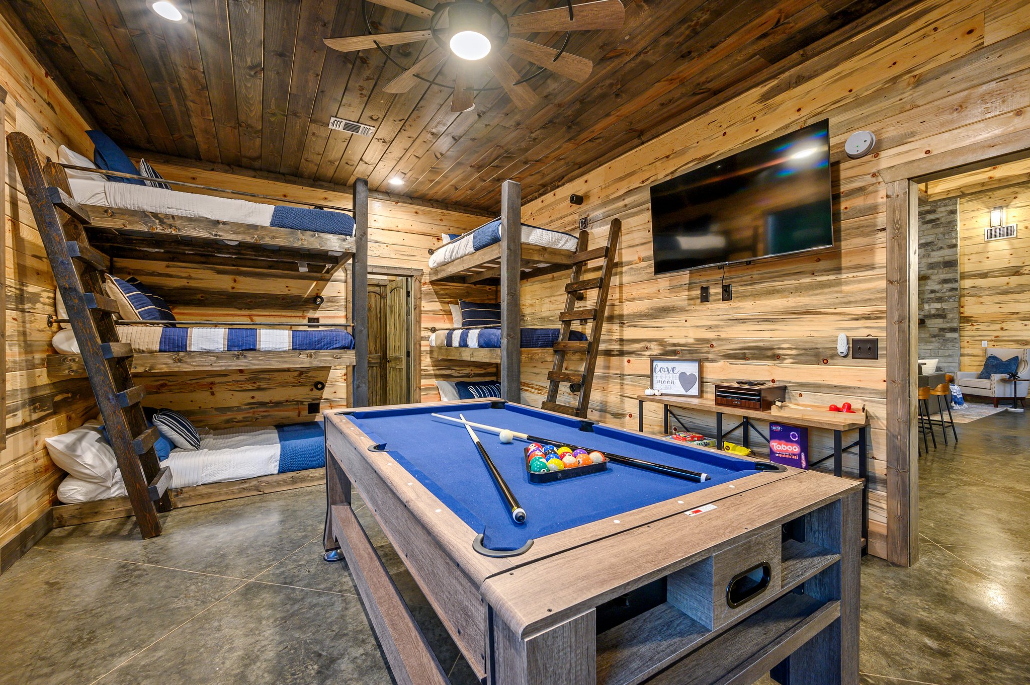 Epic game room with custom bunks and a 3-in-1 pool/air hockey/ping-pong table.