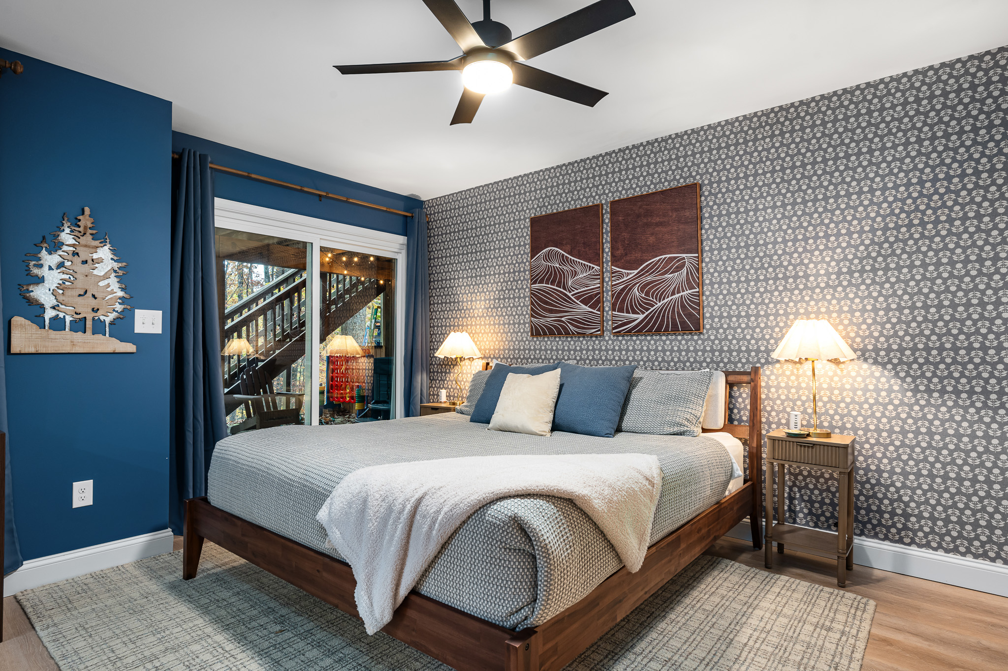 Wake up to forest views in this spacious bedroom with walkout deck access. A peaceful retreat for early risers who love morning coffee outdoors or anyone craving quiet moments away from the main gathering spaces.