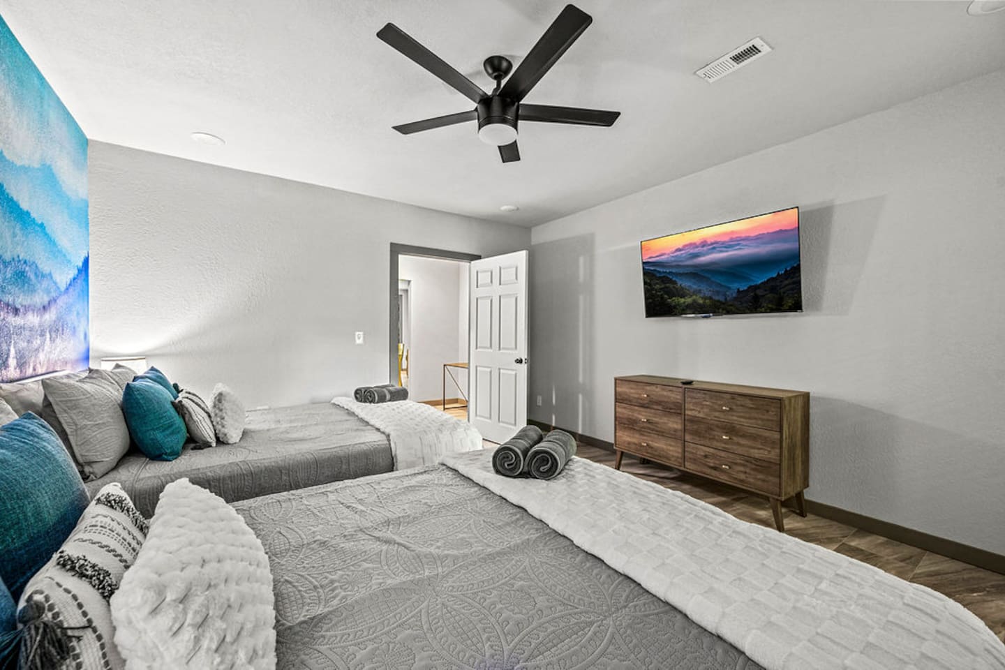 Downstairs bedroom with two queen beds and TV.