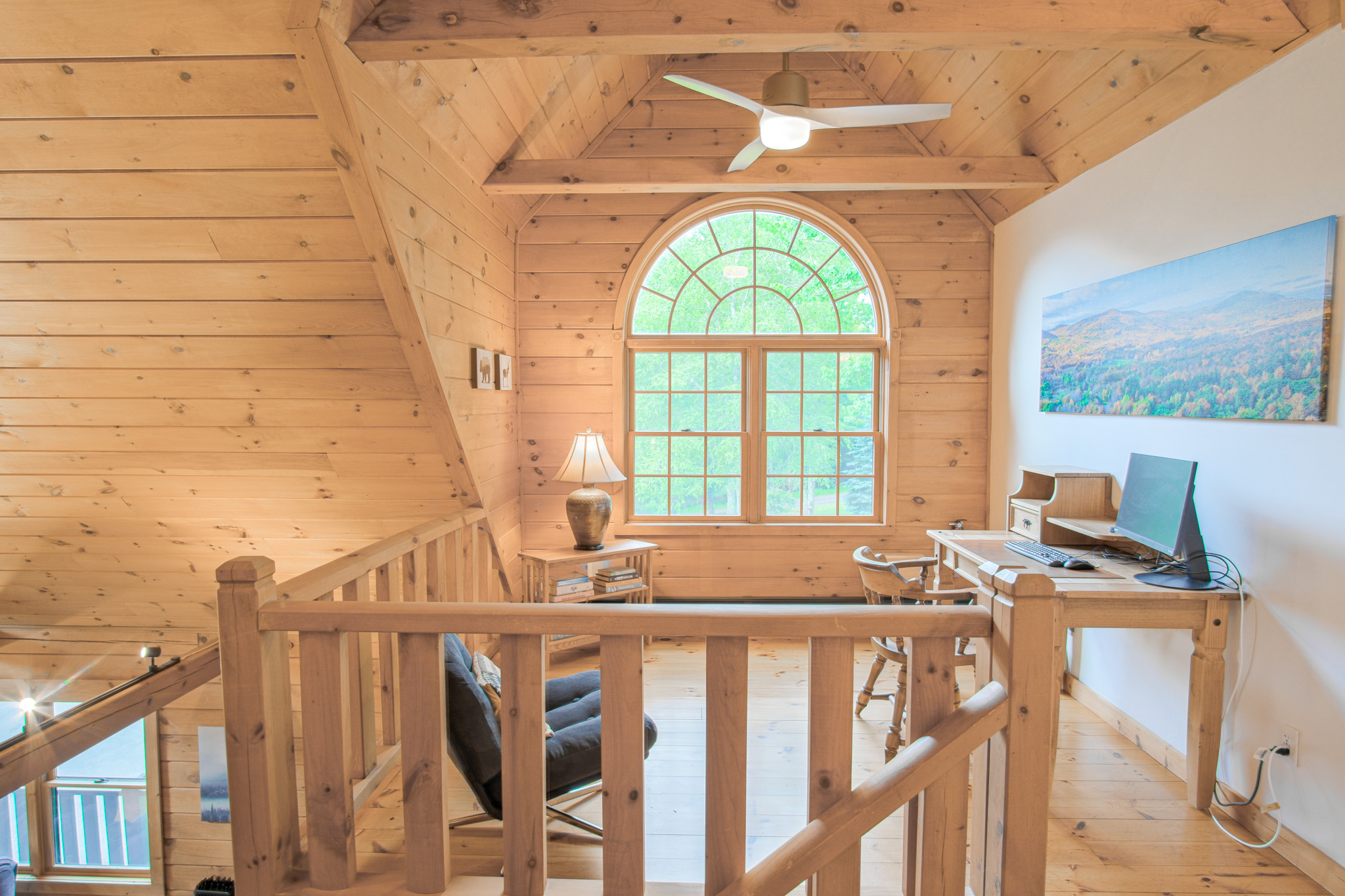 The mezzanine also offers a fully-functional work space. Monitor, keyboard, mouse, and fast wifi. Bonus: your zoom background will be the massive cathedral ceiling of the family room