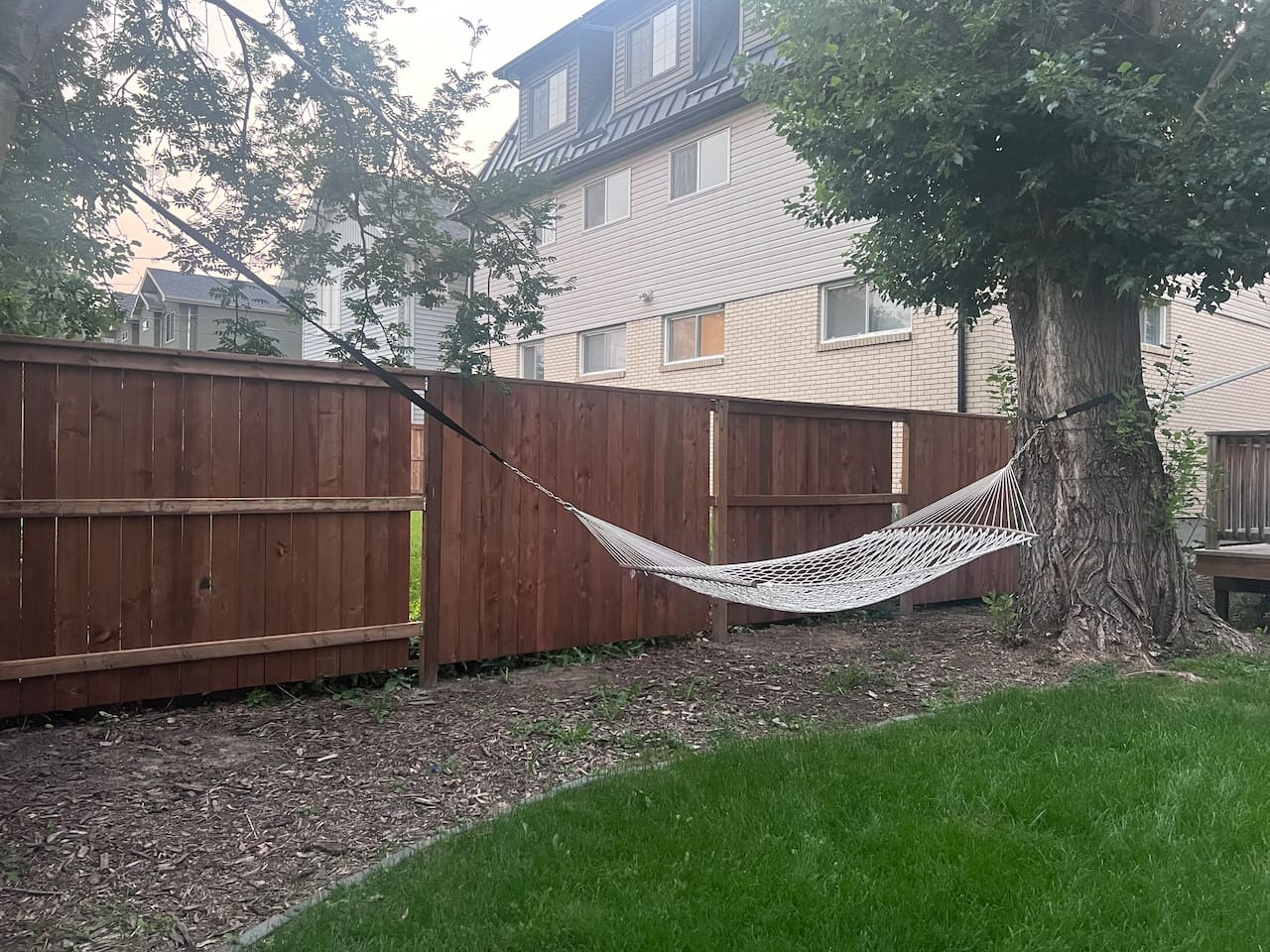 Relax in the hammock in the south facing back yard. Available from May - September. 