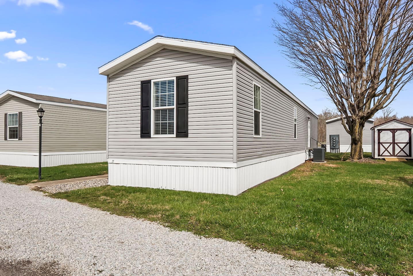 Spacious outdoor setting with grassy areas and neighboring homes in a peaceful community environment.