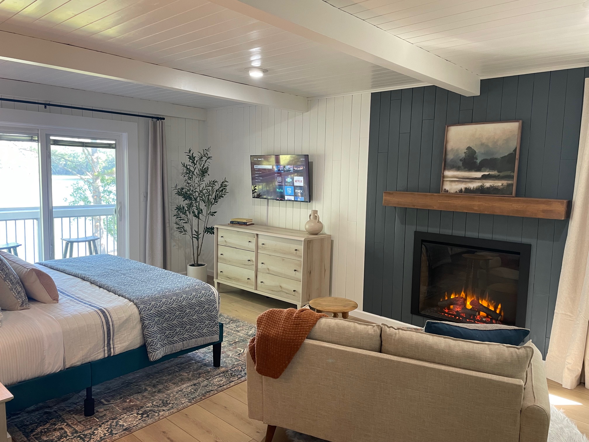 Bedroom 1 - King bed, ensuite bathroom, lake view and balcony, sitting area with electric fireplace