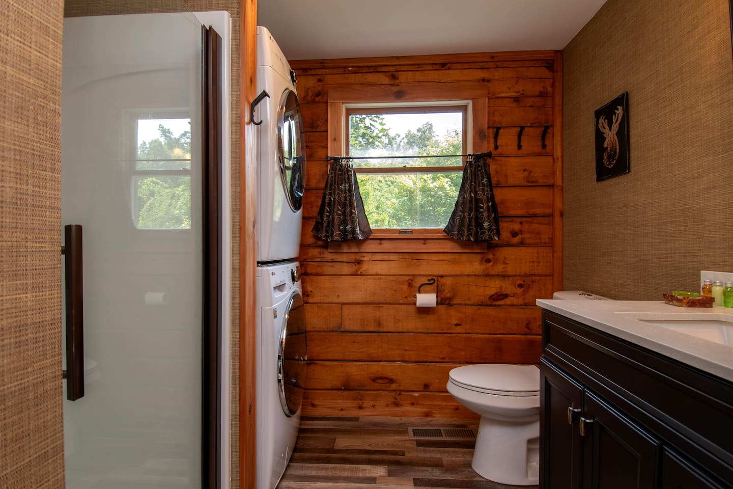 First floor bathroom with washer, dryer, iron and ironing board. Laundry detergent provided.