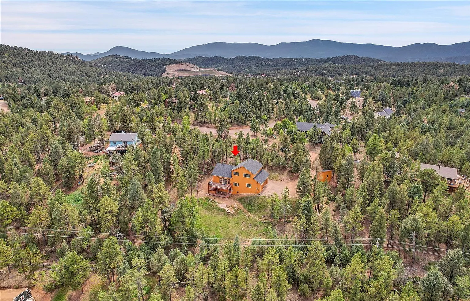 Expansive aerial perspective showing the cabin's secluded setting.