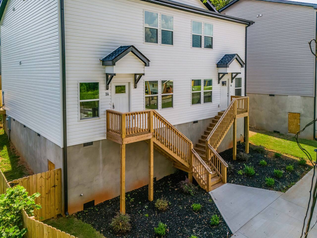 Welcoming entrance with a flight of stairs leading up to the front door, adding a touch of character to your arrival.
